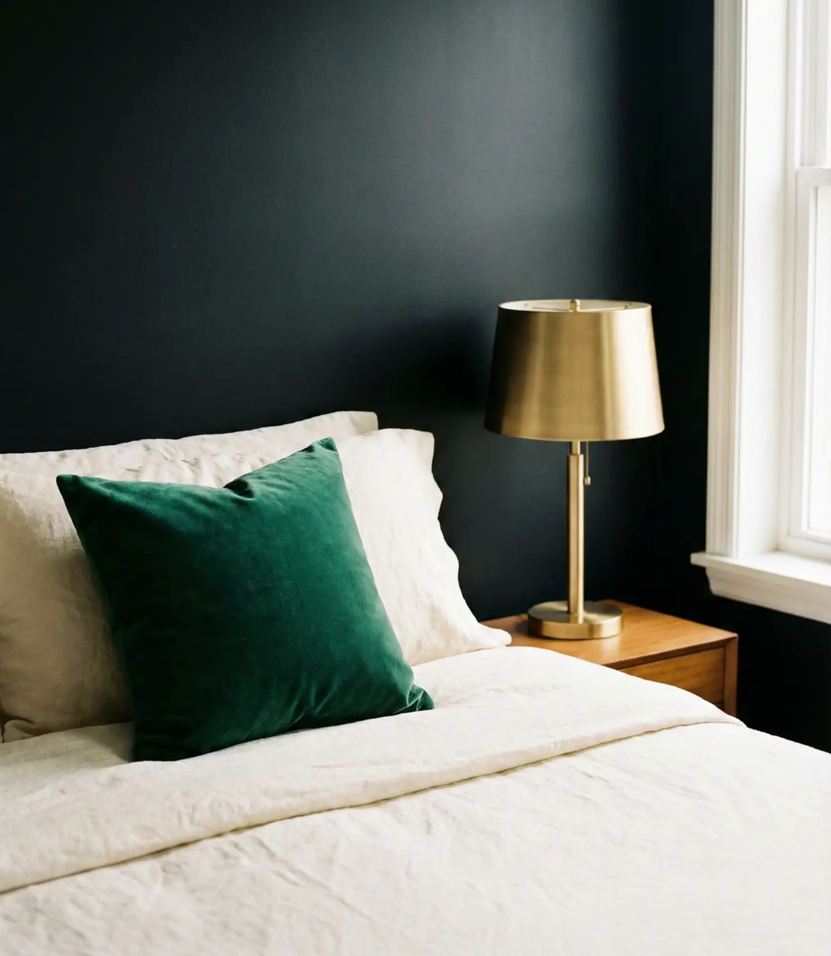 Black Accent Wall with Green Bedding for a Fresh Contrast 1