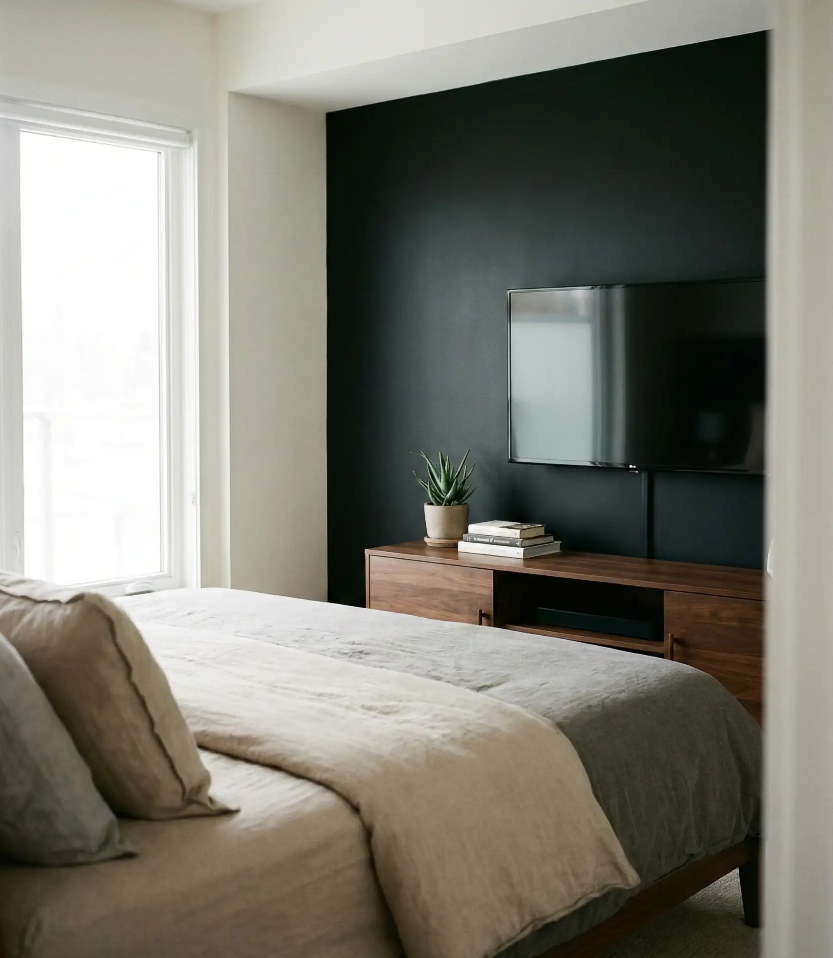 Black Wall with TV Mount and Minimalist Setup 2