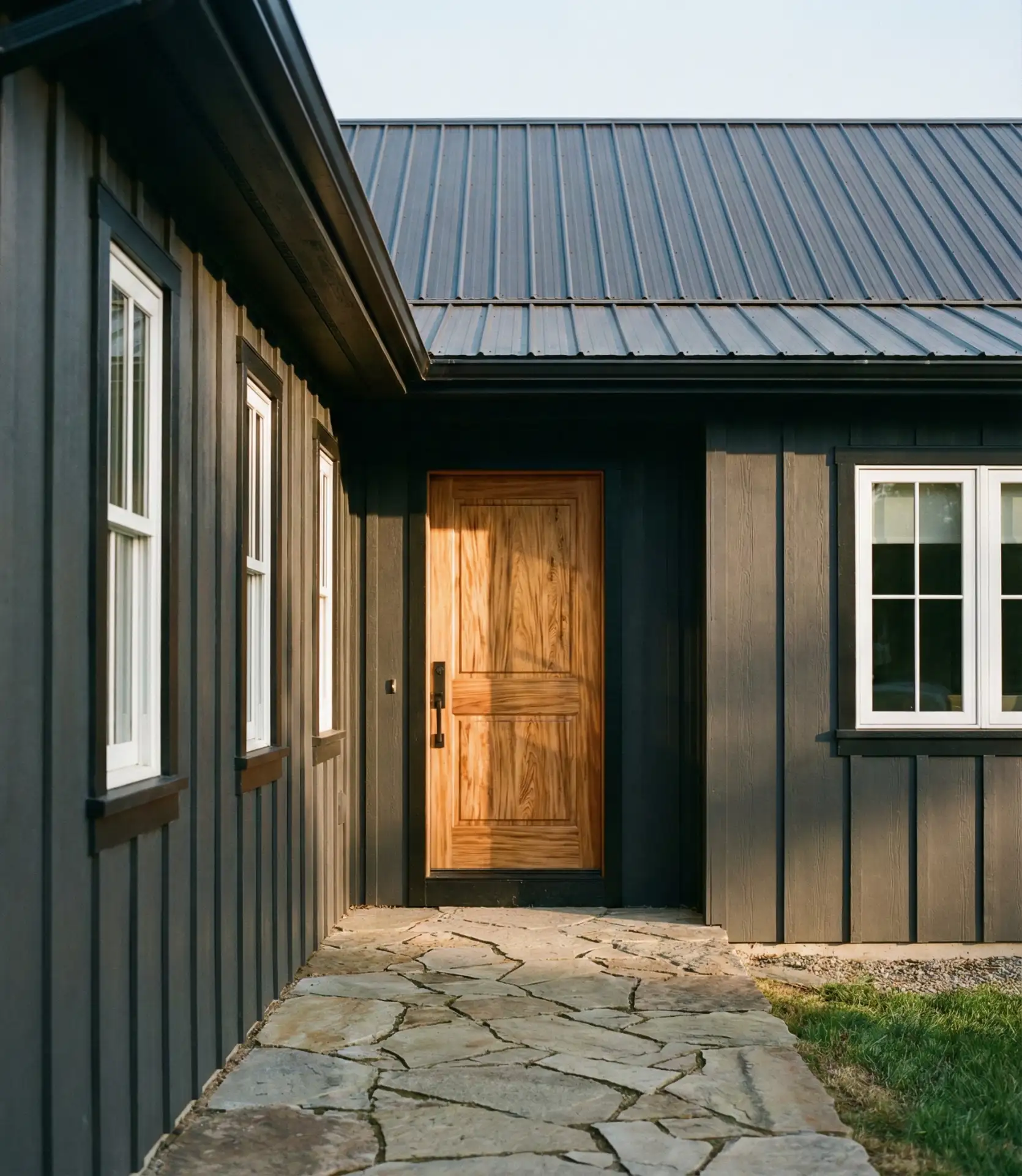 Dramatic Dark Exterior with Natural Wood Door 2