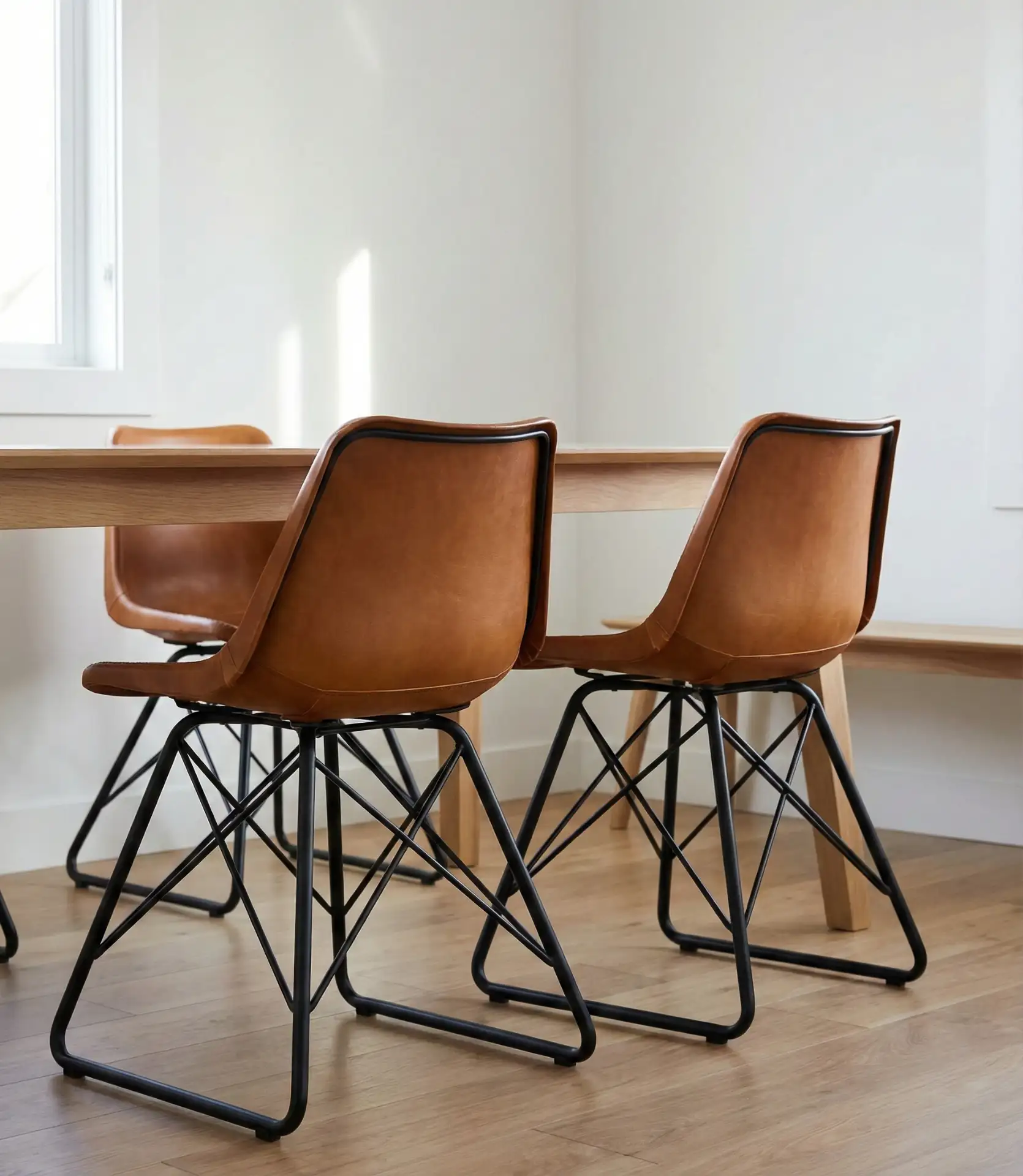 Sculptural Leather Dining Chairs with Metal Accents 1