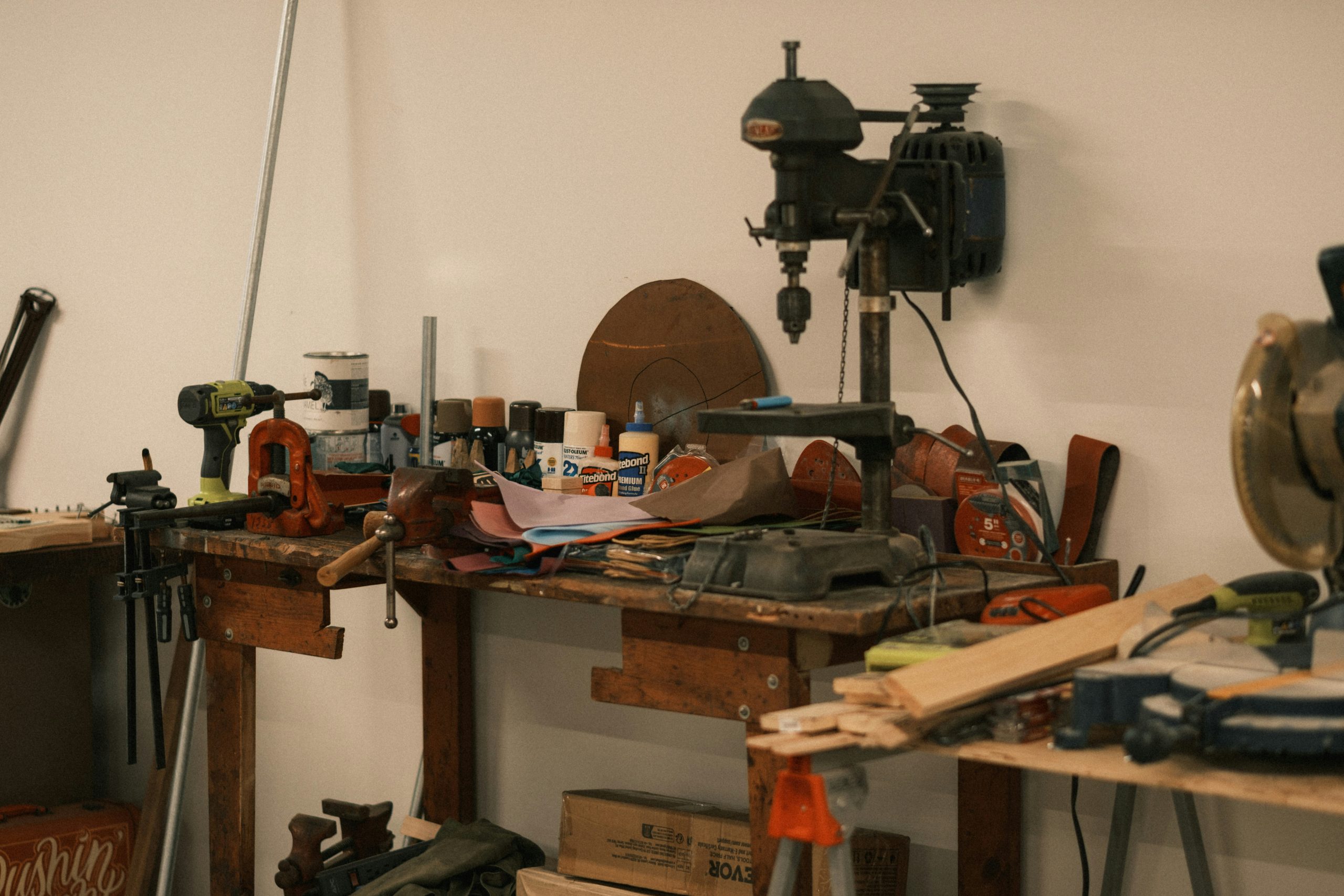 A cluttered workbench with tools and supplies.