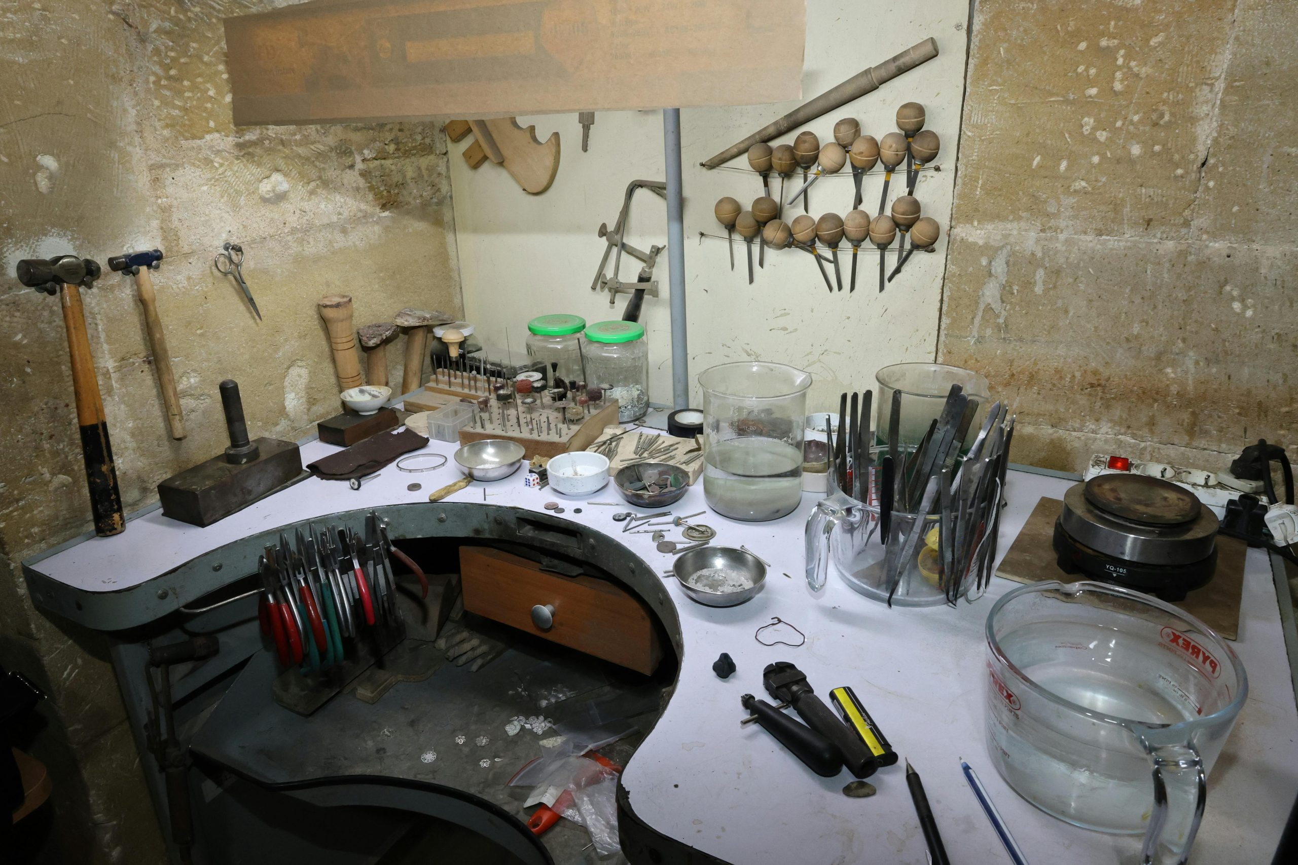 Intricate tools and equipment in a jewelry maker's workshop, showcasing craftsmanship.