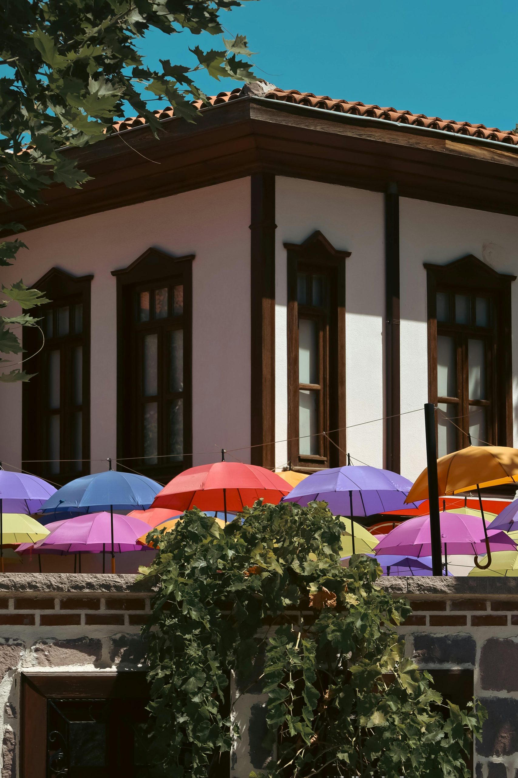 Vibrant umbrellas adorn an outdoor café in Ankara, enhancing its charm with bright colors and decor.