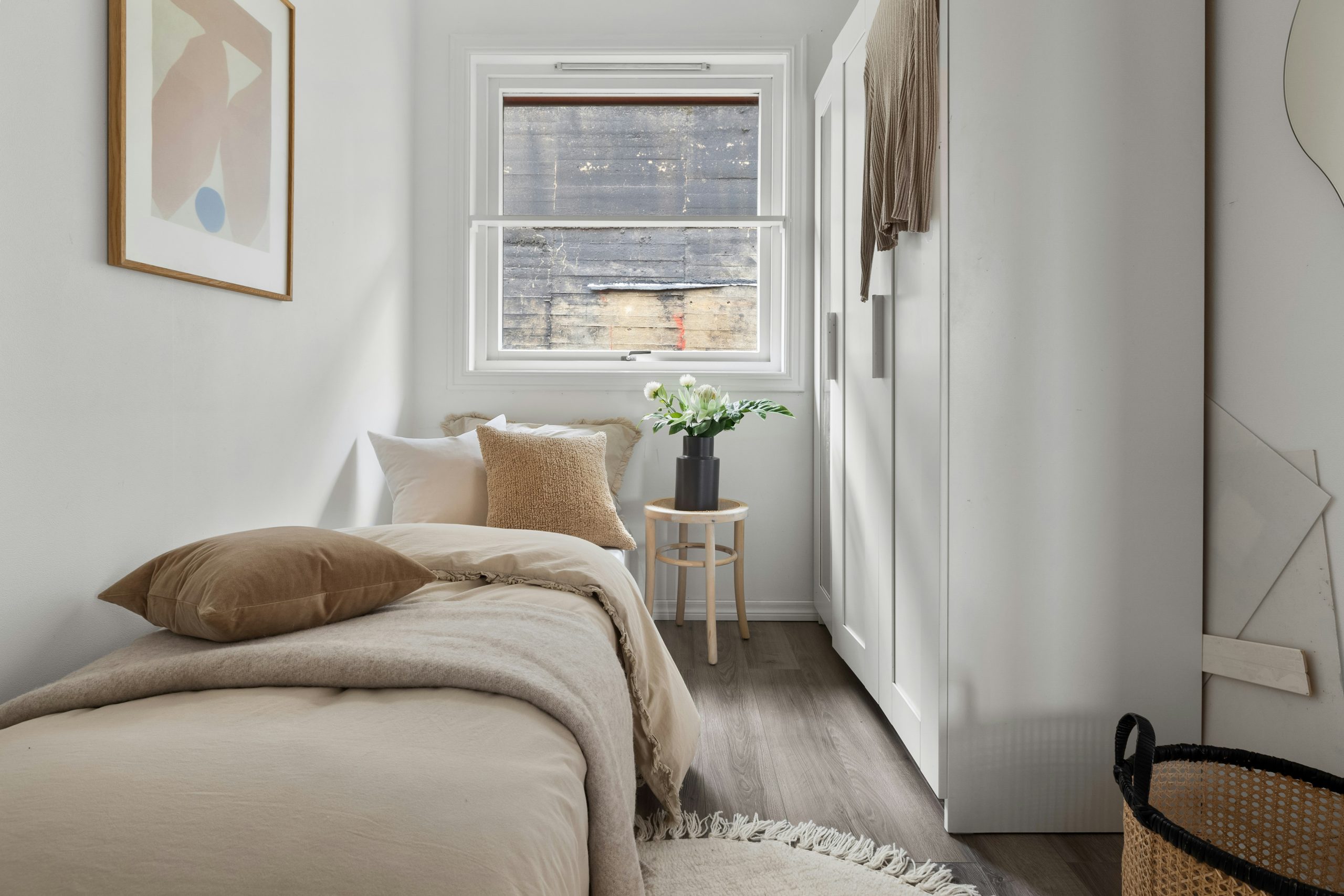 A bedroom with a bed and a window