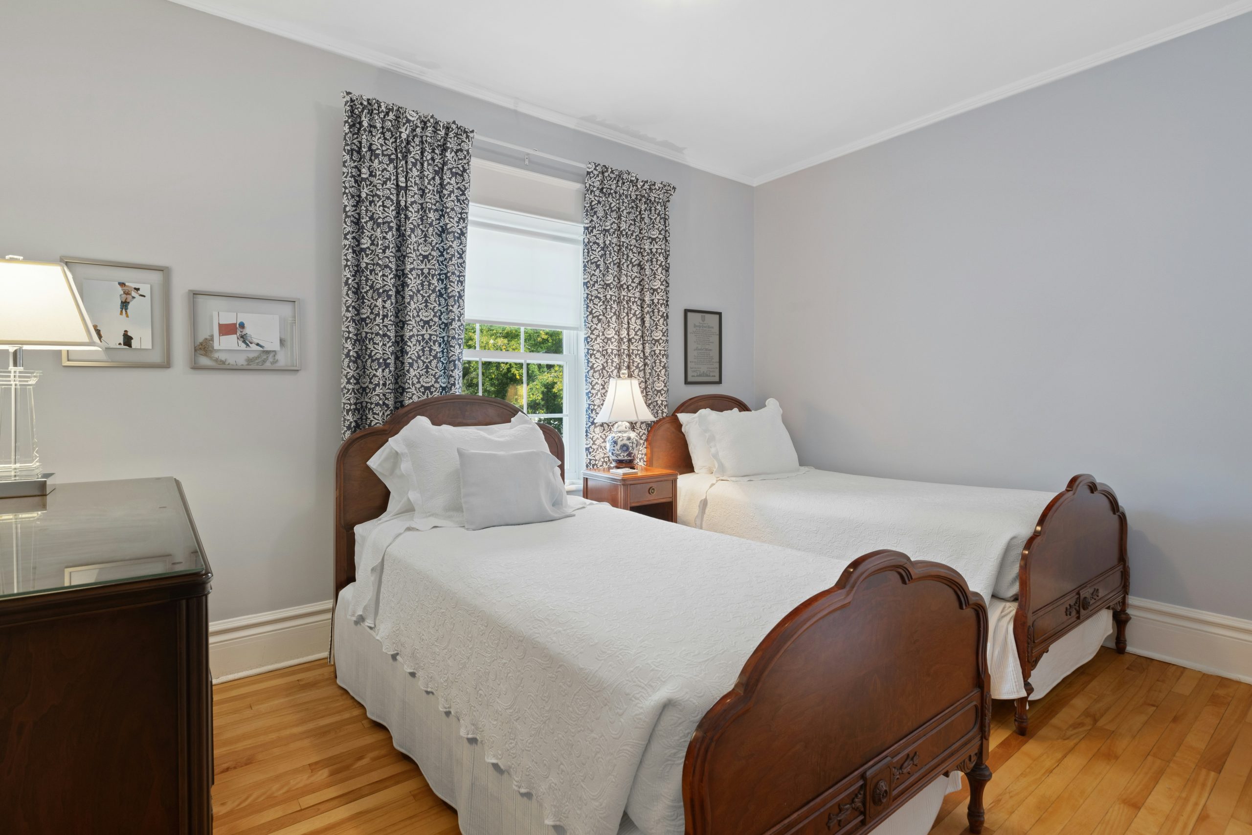 a bedroom with two beds and a desk