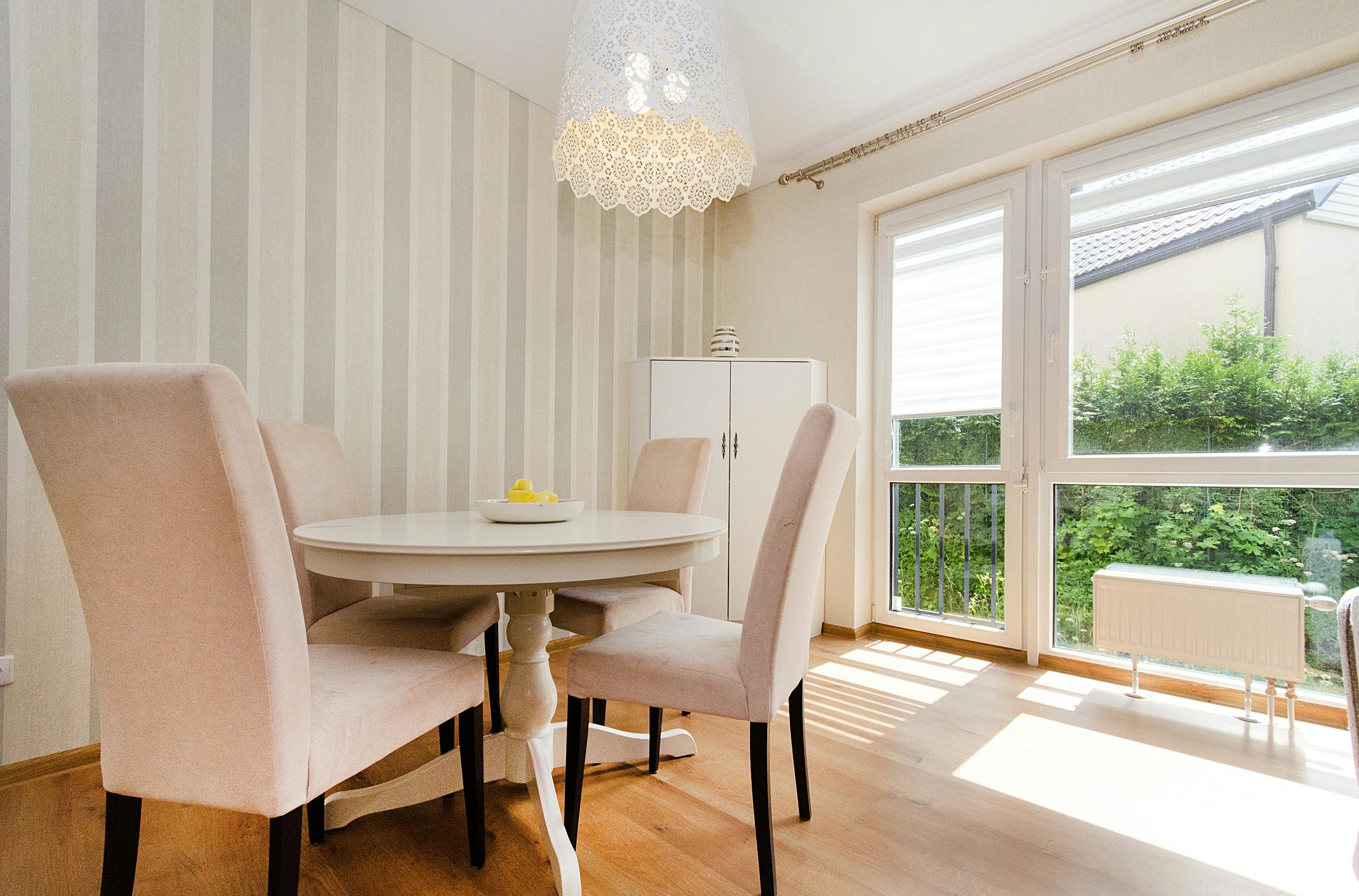 A bright and modern dining room with elegant furniture and natural light.