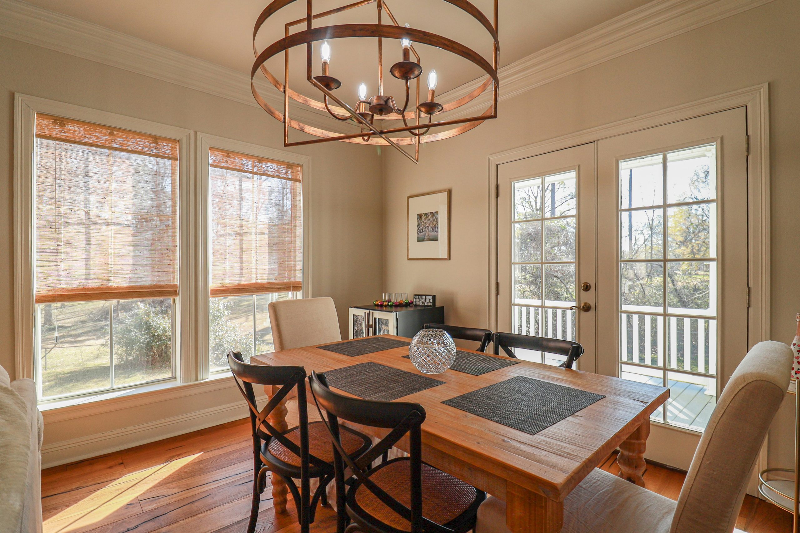 A dining room with a wooden table and chairs.