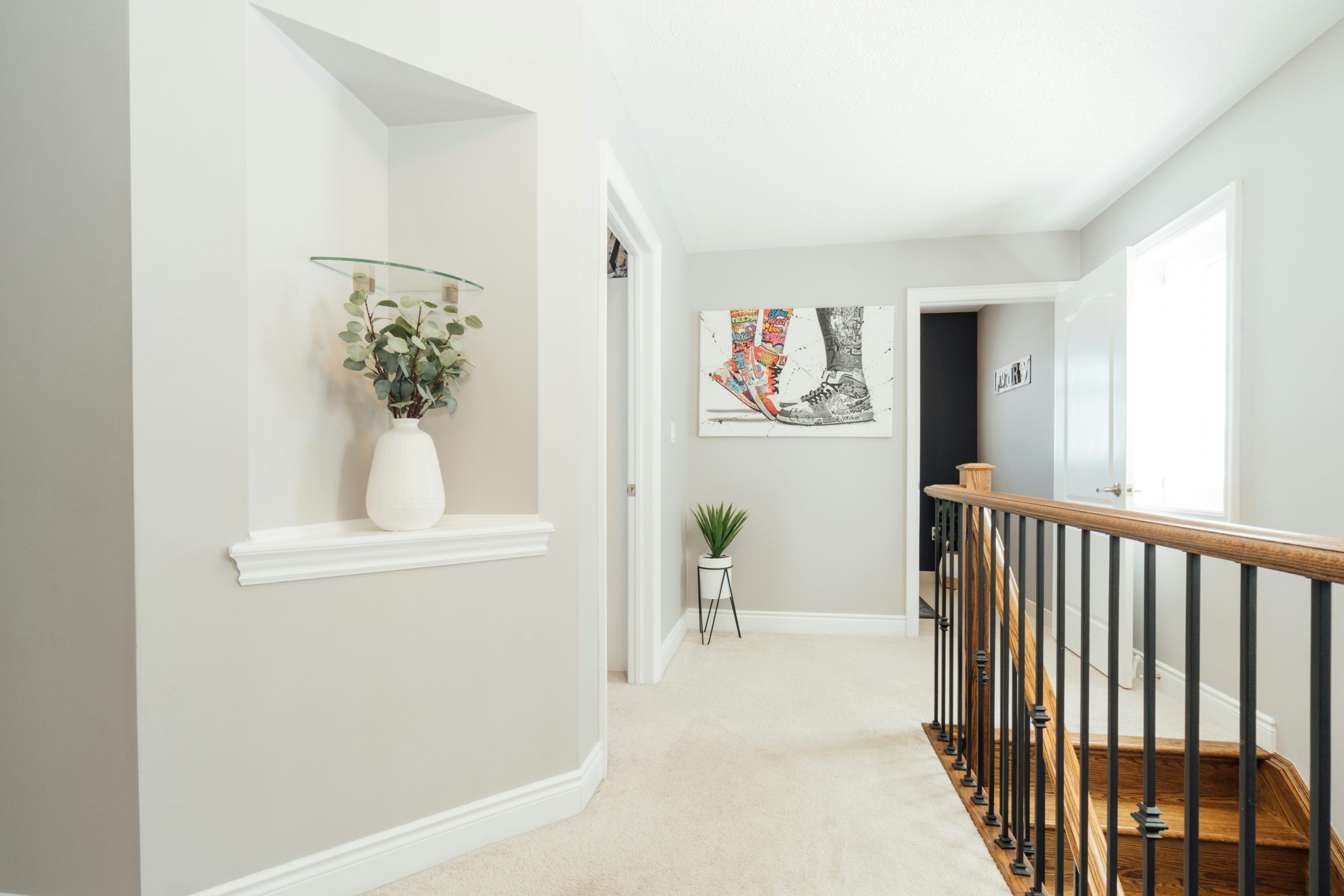 a white vase with a plant on top of it