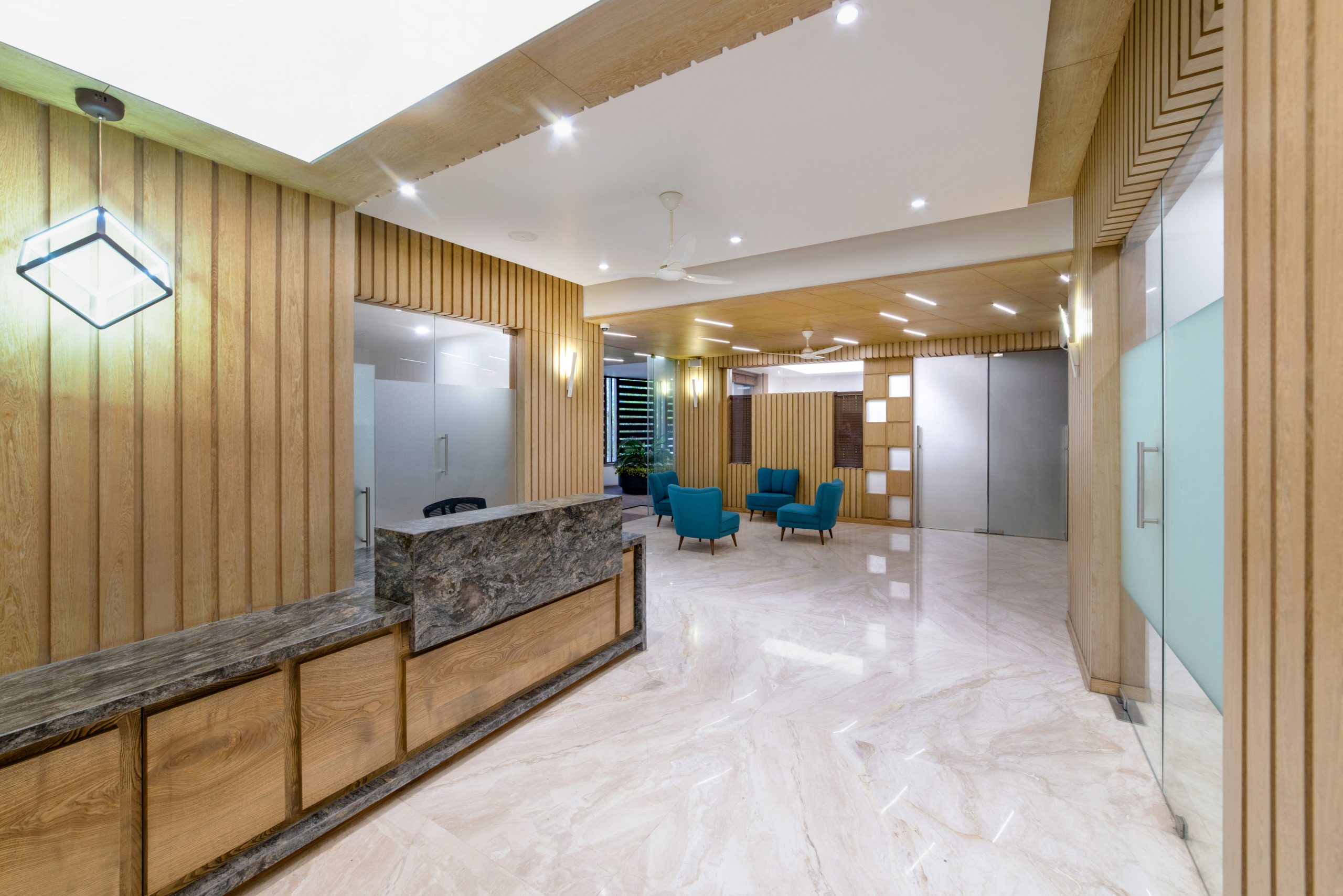 An elegant office lobby with a marble reception.