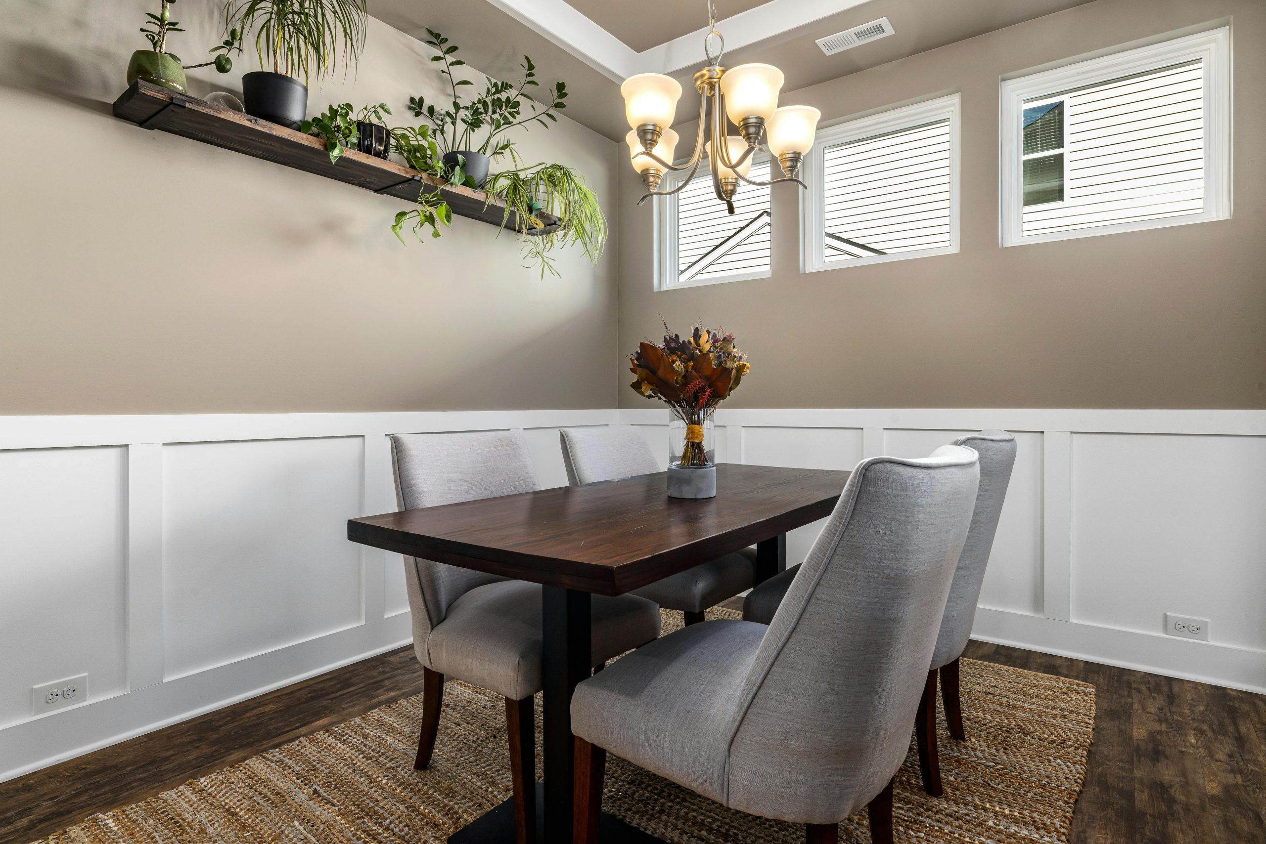 Chic dining room featuring stylish furniture, natural lighting, and wall-mounted plants.