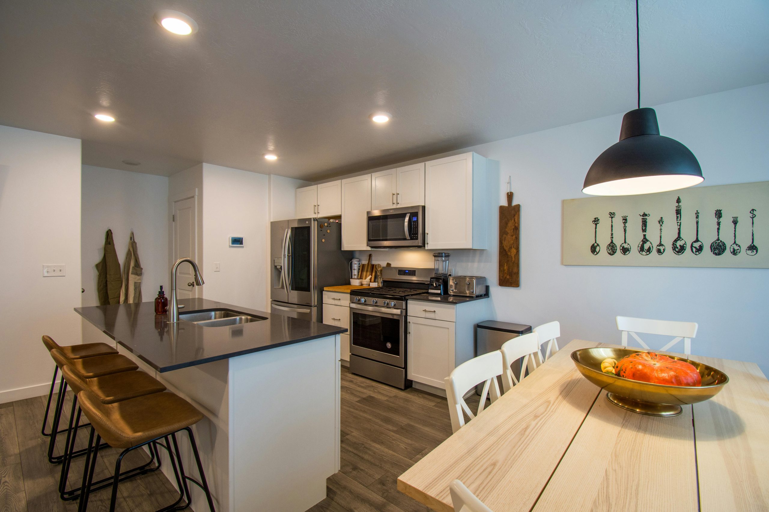 Contemporary kitchen interior with island, dining table, and stylish decor.