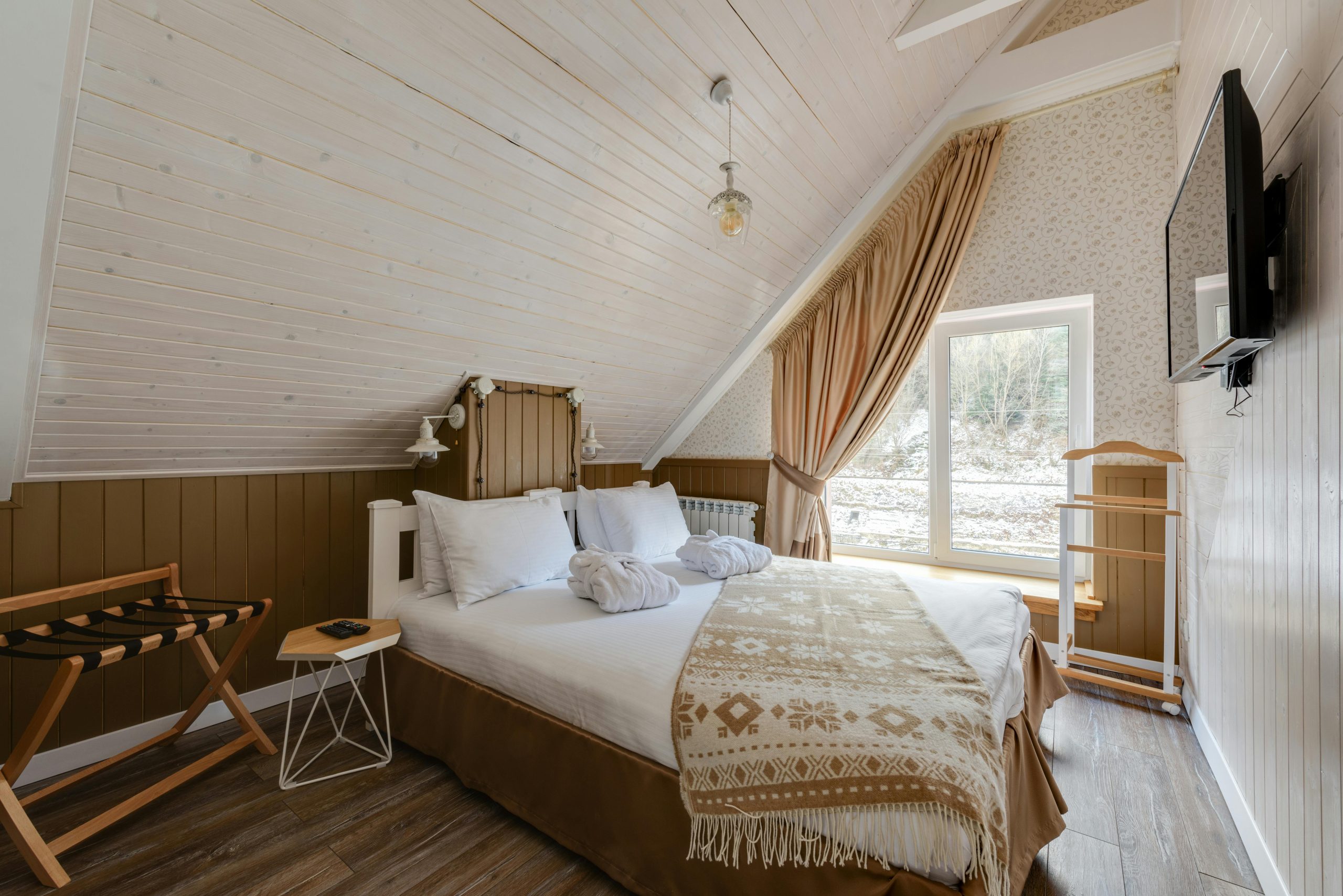 Inviting attic bedroom with modern design and natural light for a relaxing stay.