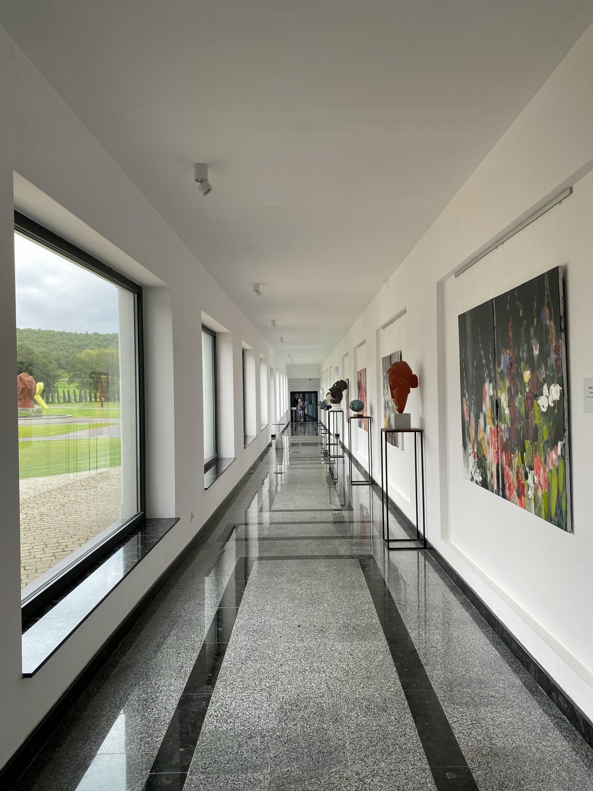 Modern Art Gallery Corridor with Sculptures · Free Stock Photo