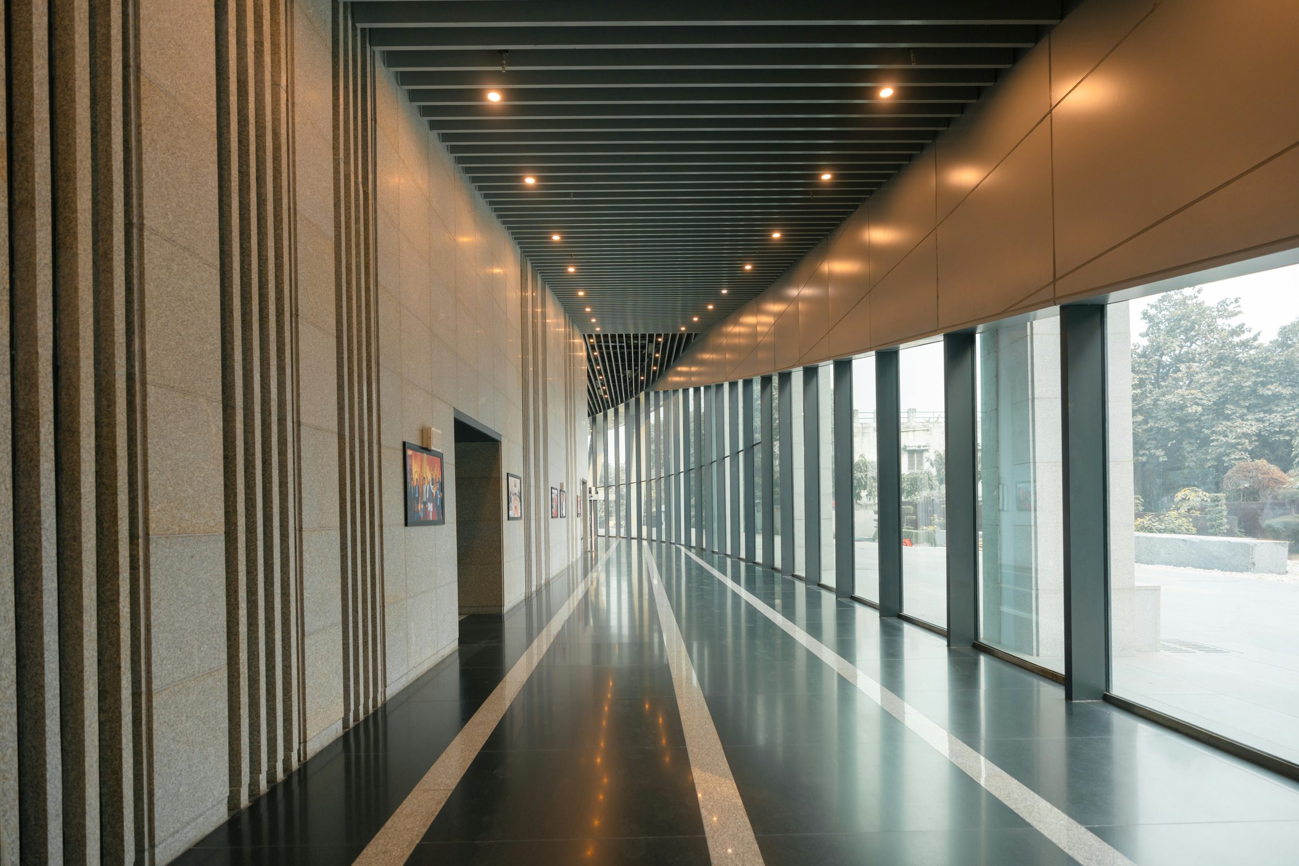 Modern hallway with large windows and reflective floor