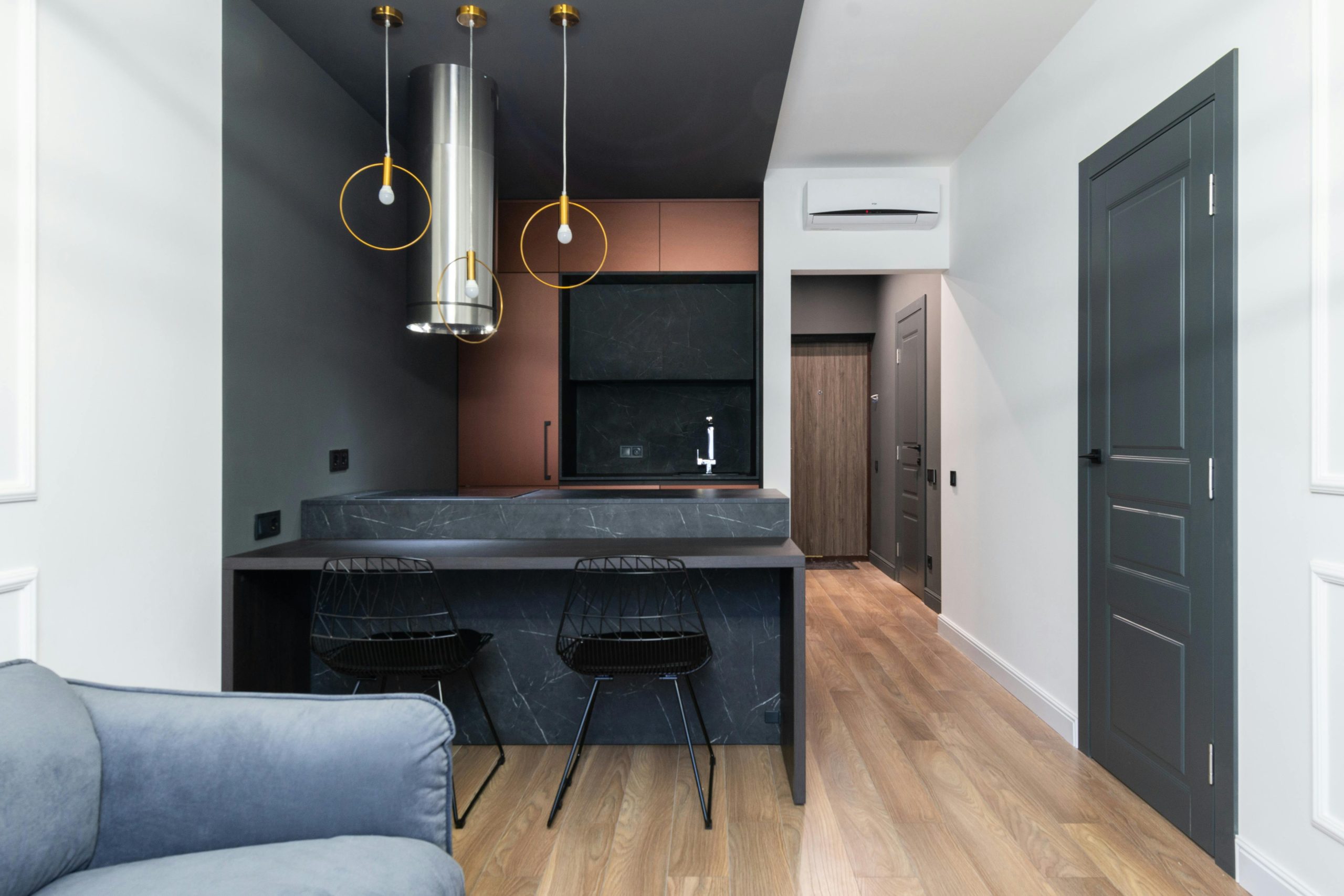 Sleek modern kitchen interior featuring minimalist design elements and a dark color palette.