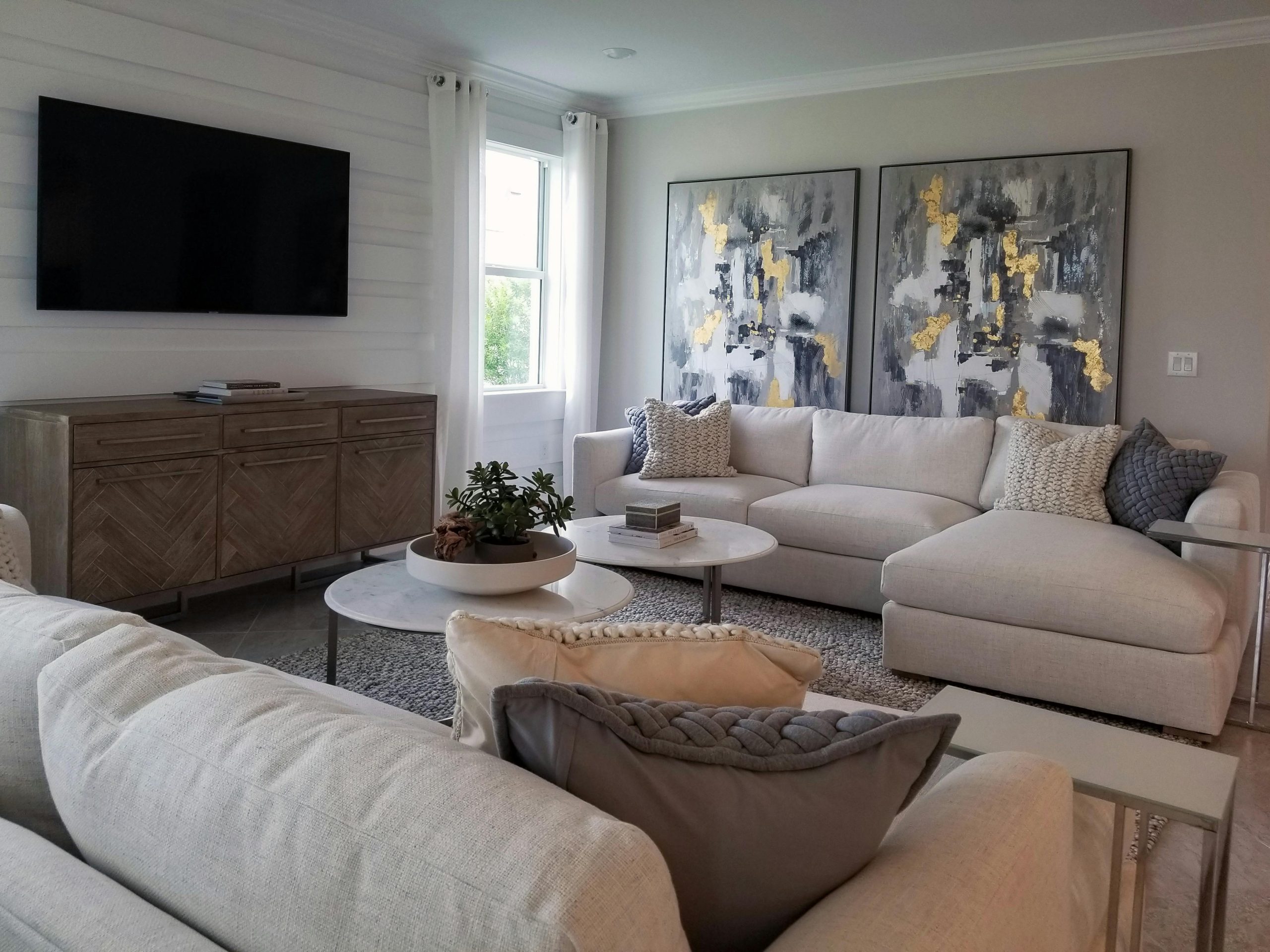 Spacious living room featuring modern sofas and abstract art for a stylish home interior.