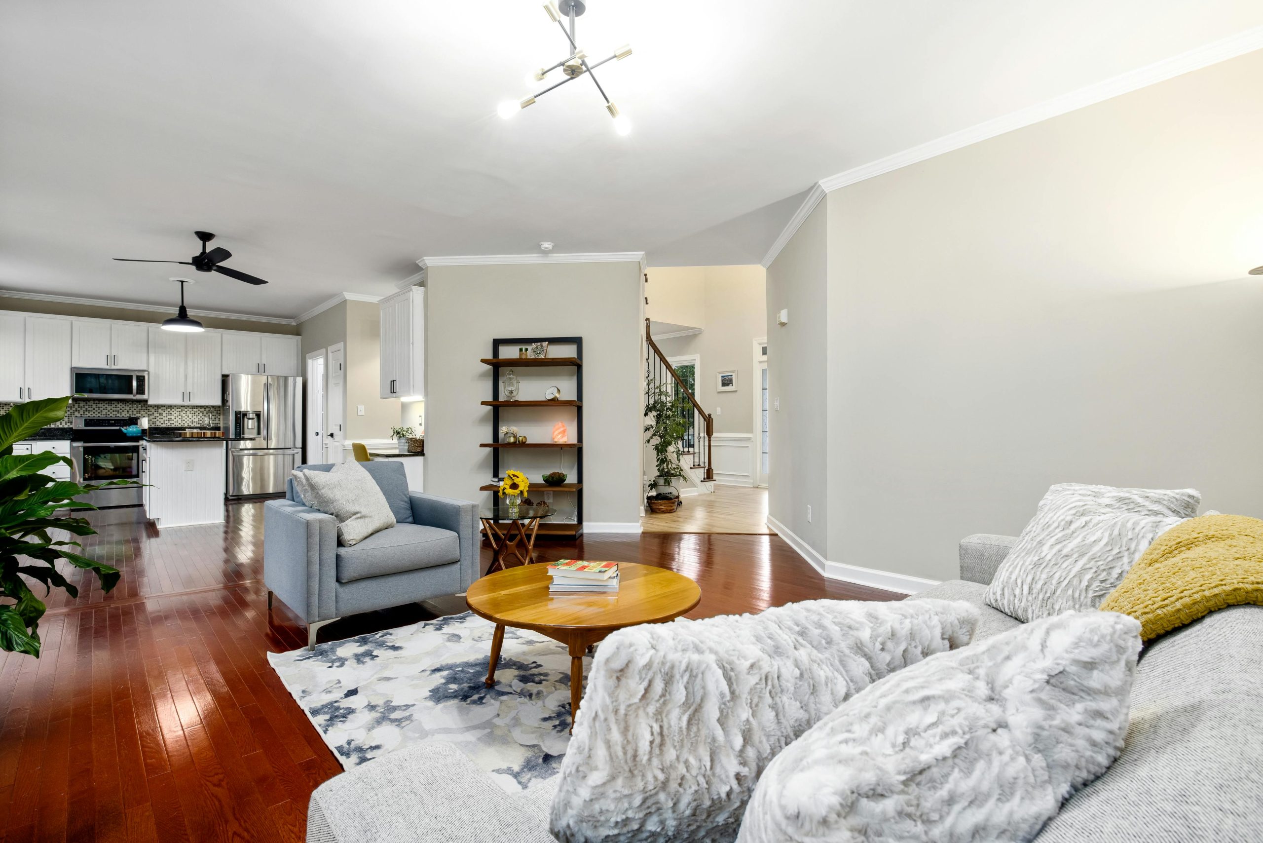 Spacious modern interior with an open layout, showcasing a cozy living room and sleek kitchen.