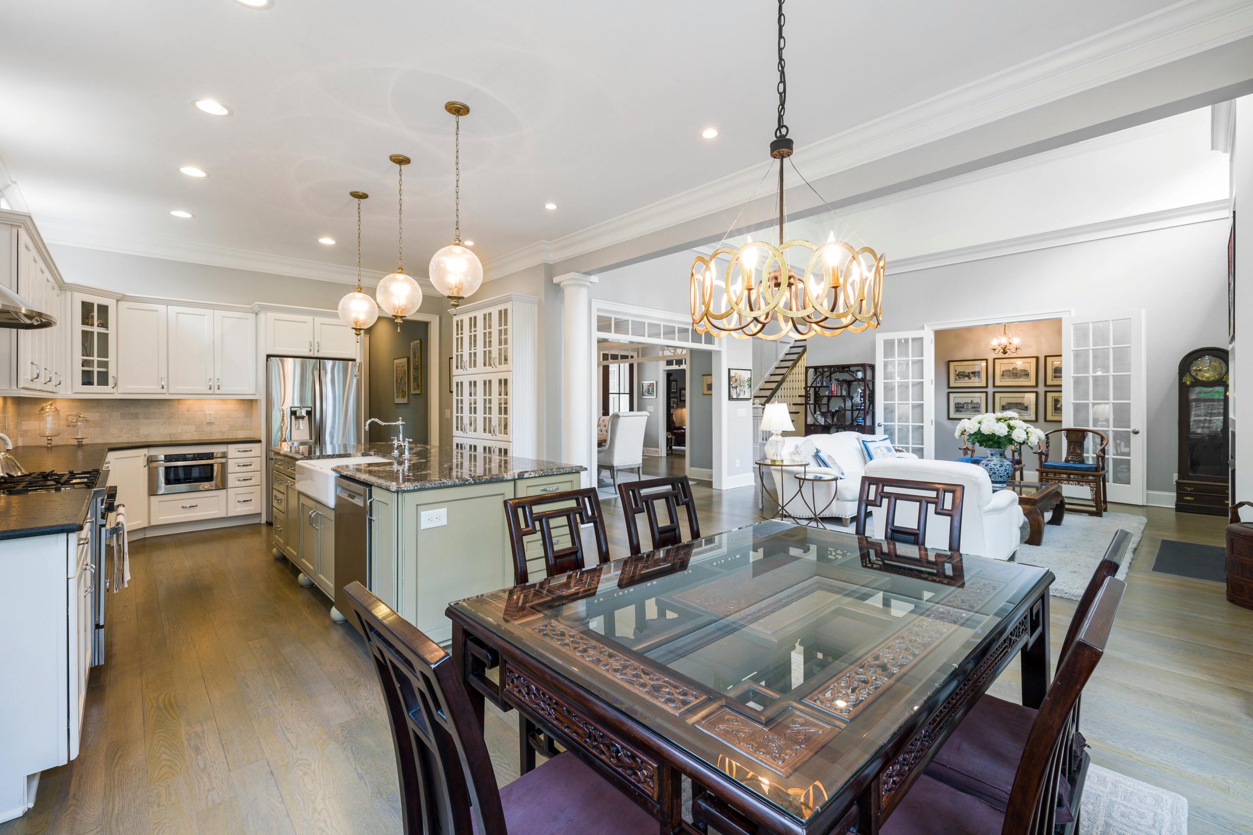 Spacious modern kitchen and dining area with elegant chandeliers and classic design.