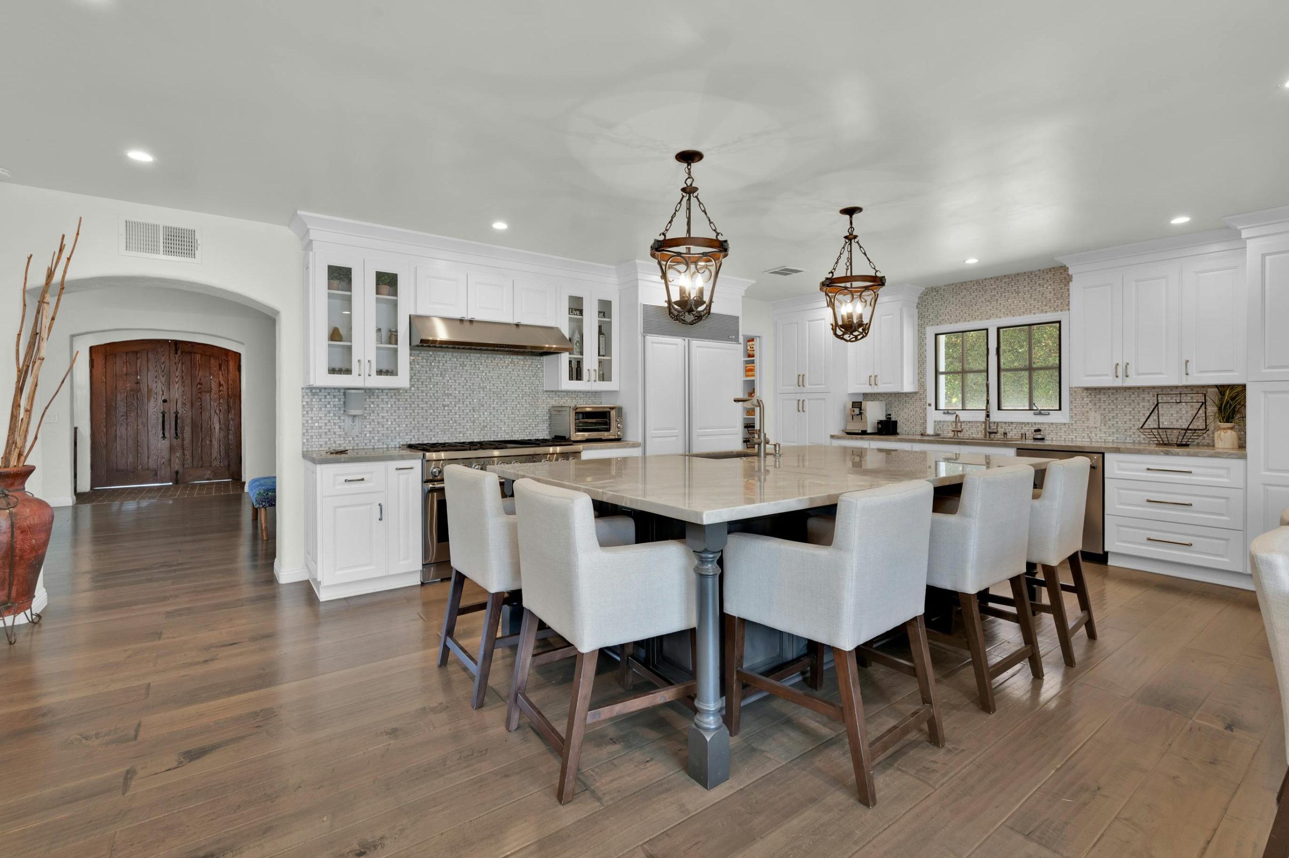 Spacious modern kitchen design featuring high-end furniture and lighting in a sophisticated setting.