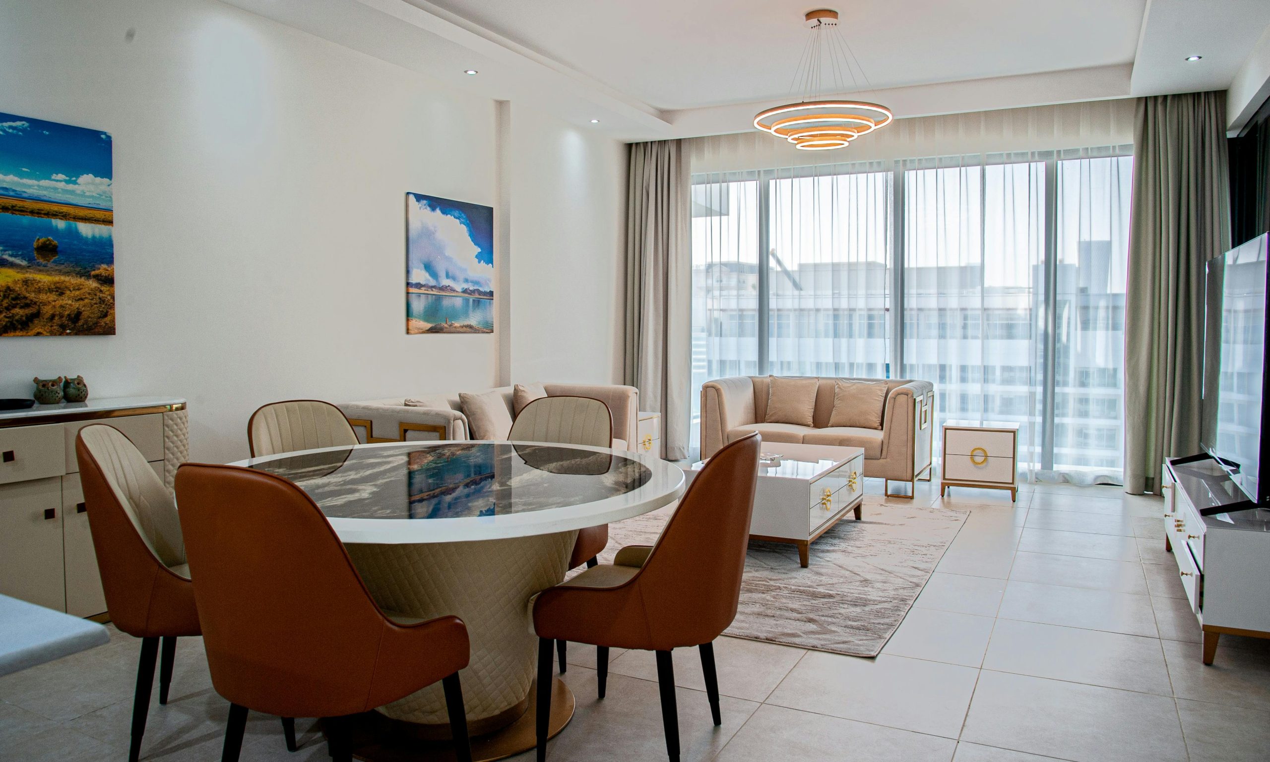 Spacious modern living room with elegant furnishings in a high-rise apartment.