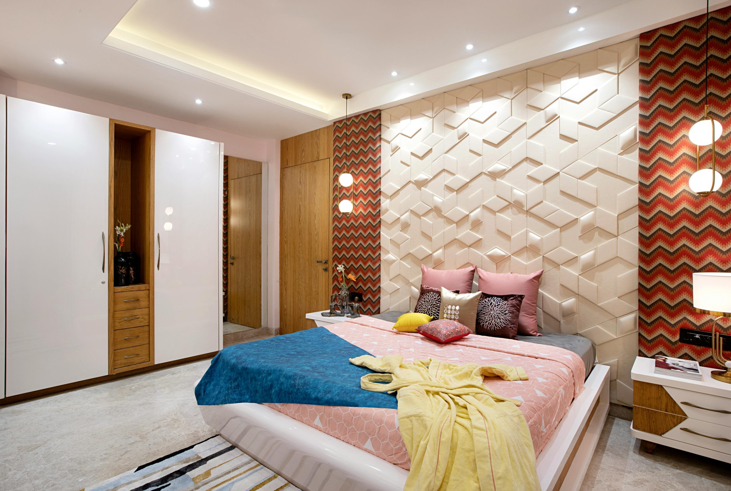 Stylish bedroom featuring geometric wall pattern and modern decor elements.