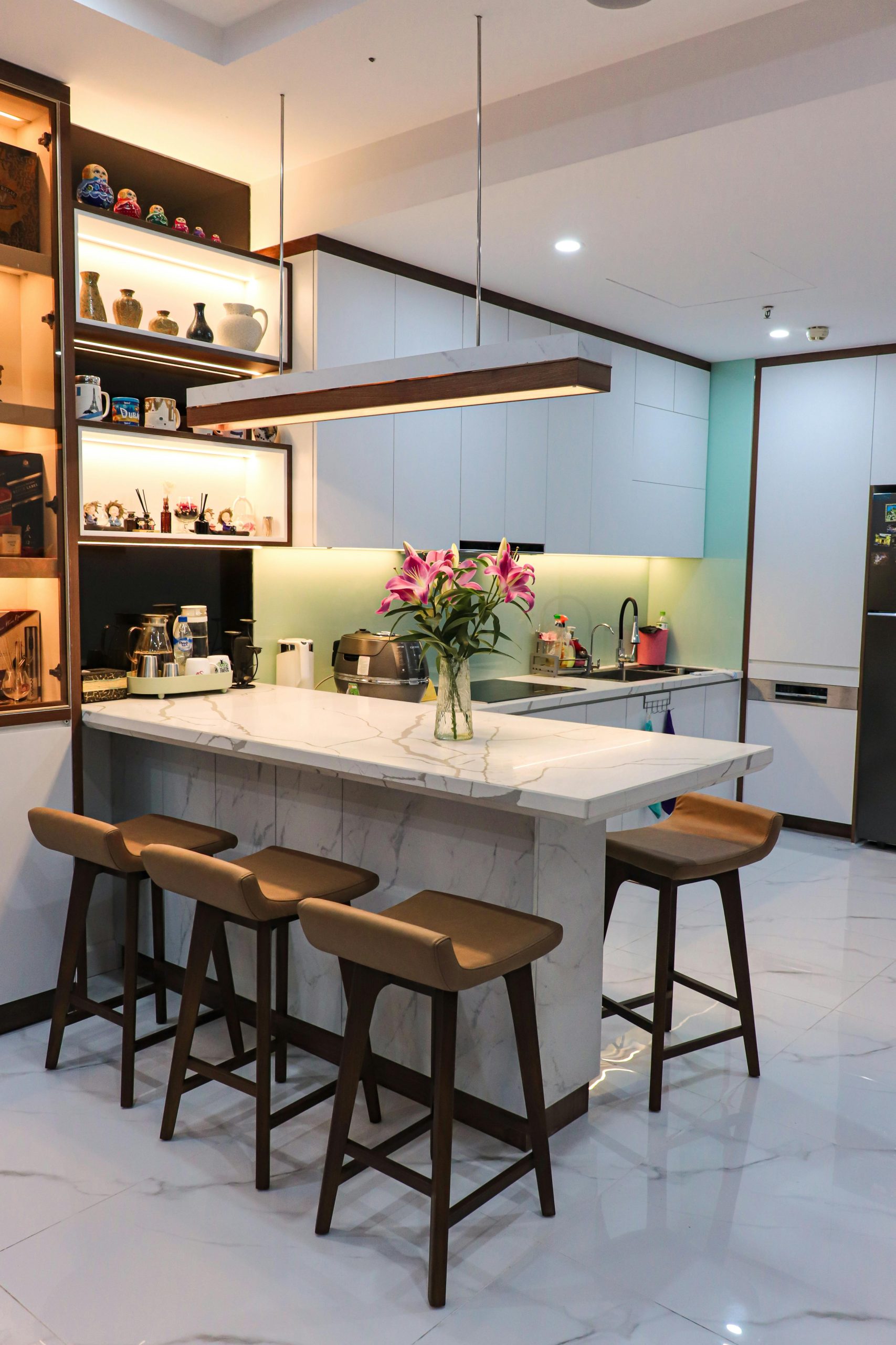Stylish kitchen with a marble island, bar stools, and contemporary decor.