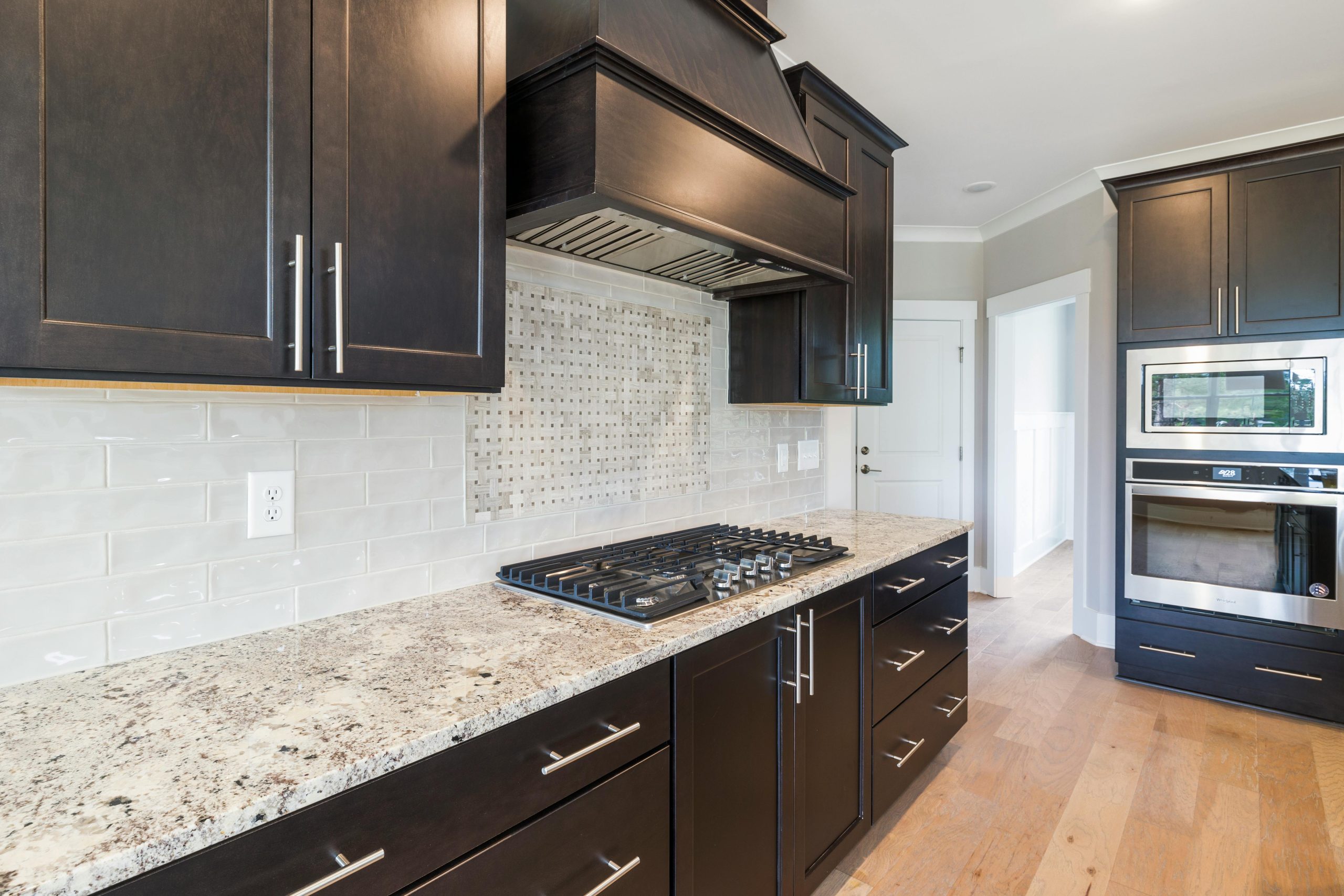 Stylish modern kitchen featuring granite countertops and dark cabinets.