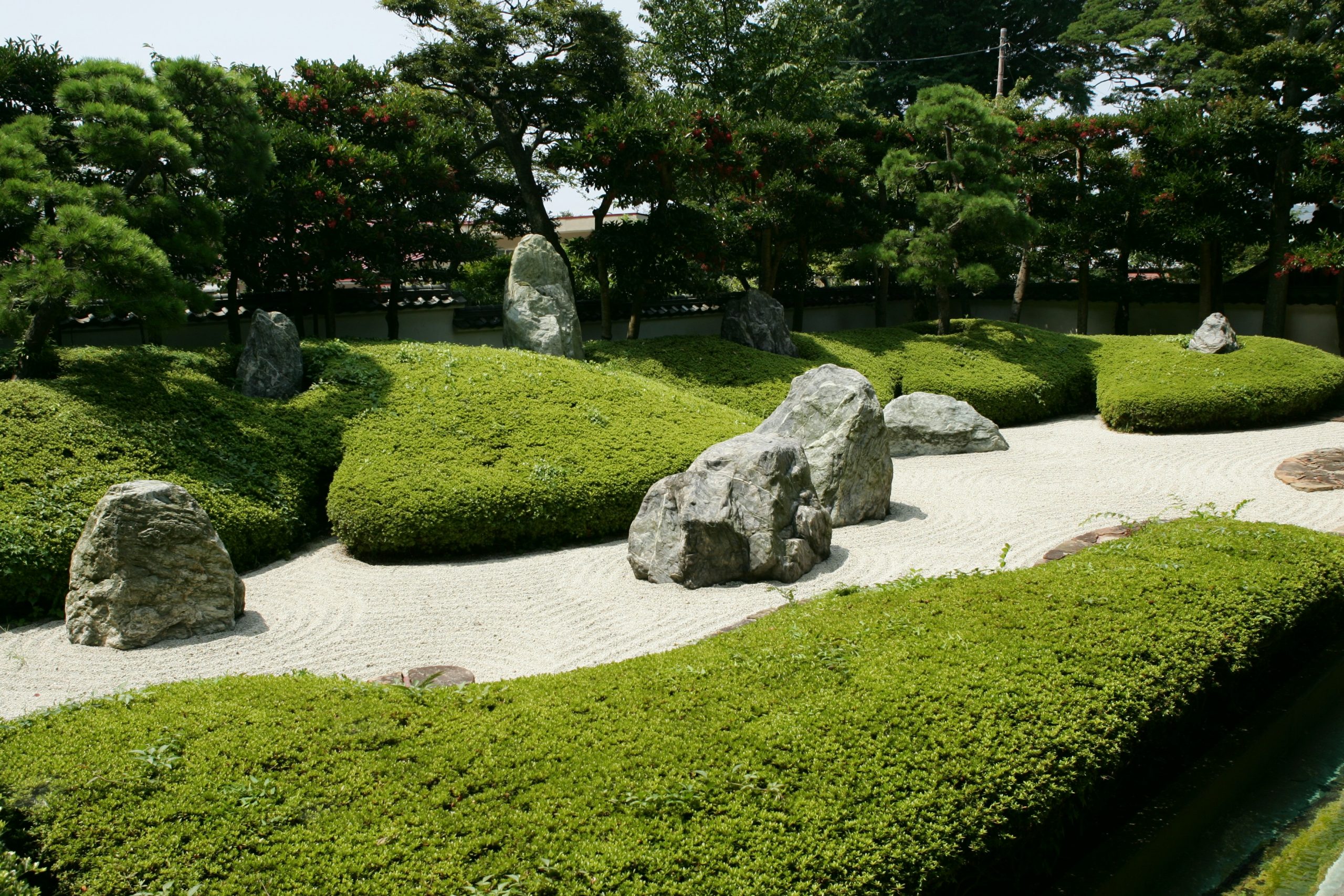 Zen garden with rocks and manicured bushes