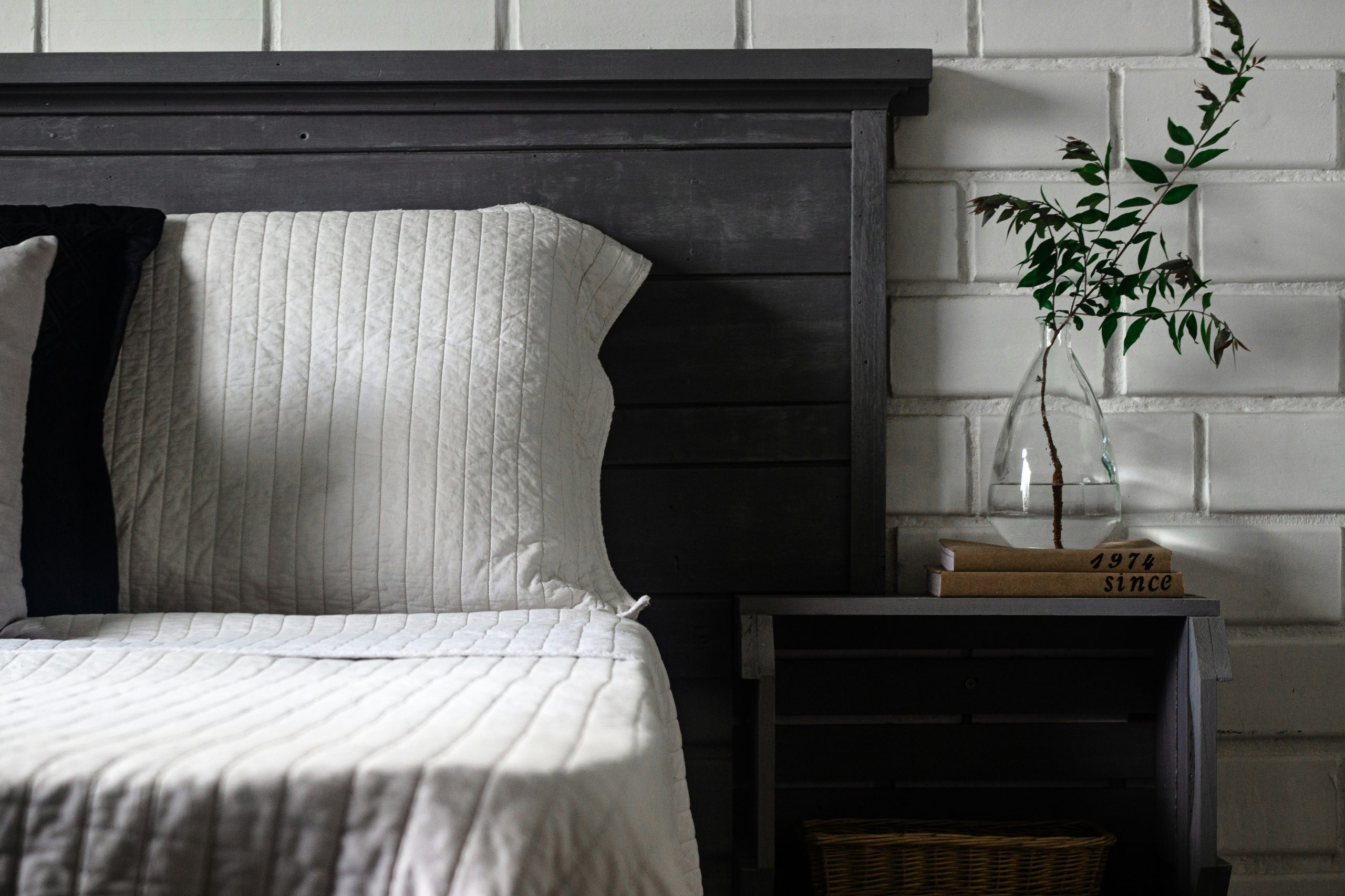 a bed with a vase of flowers