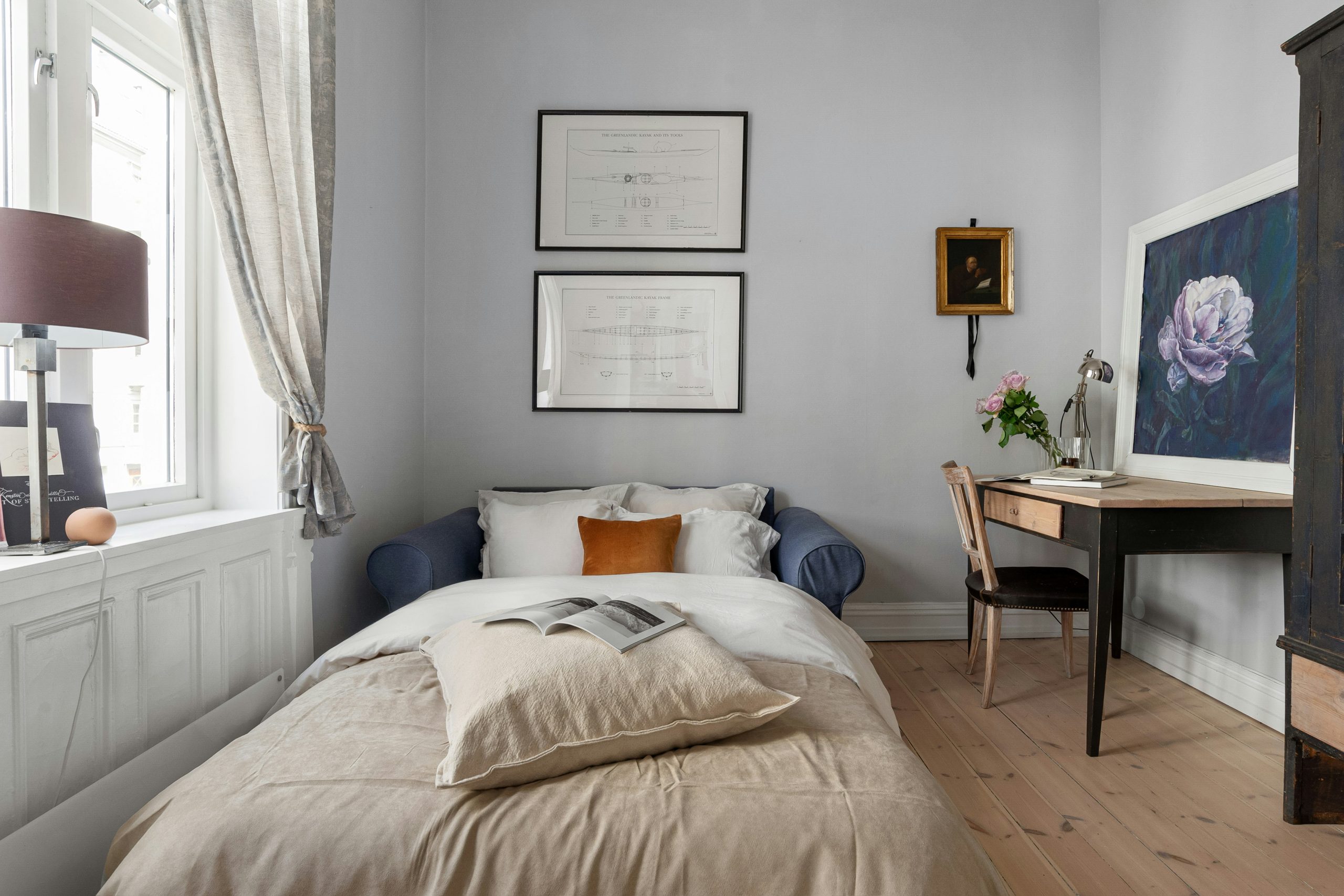 A bedroom with a bed and a desk