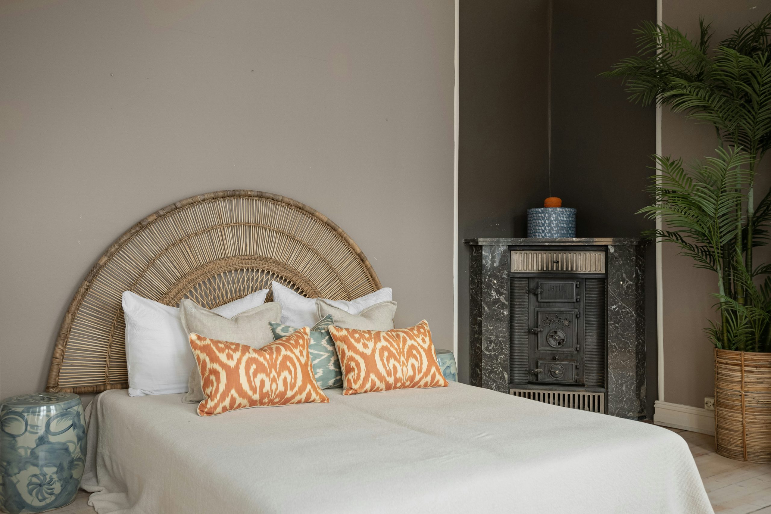 A bedroom with a large bed and a wicker headboard
