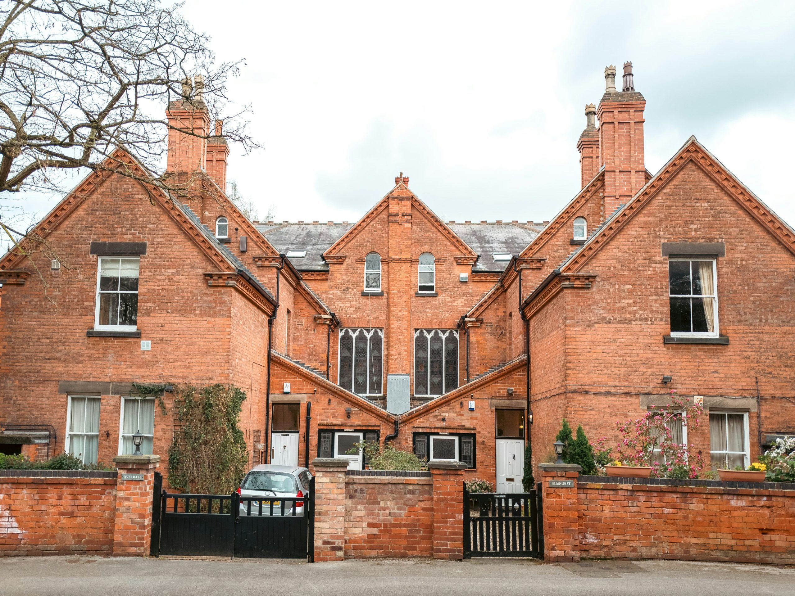 a large brick house with a black gate in front of it