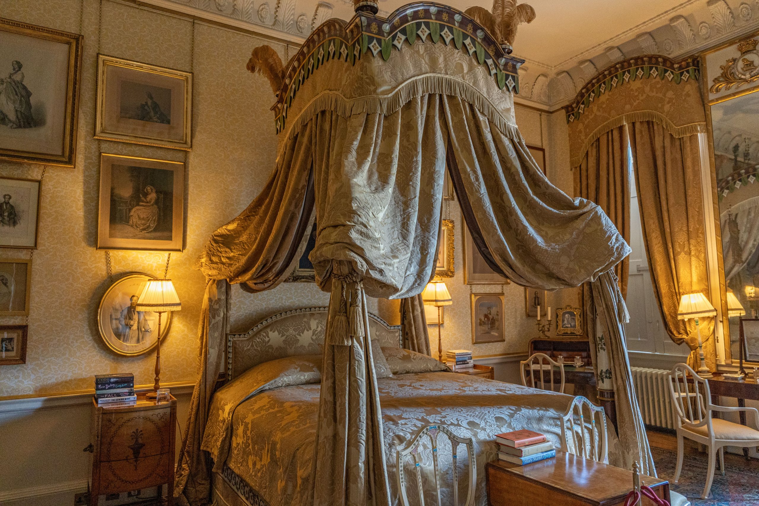 A lavish Victorian bedroom with a canopy bed and antique decor at Castle Howard, England.