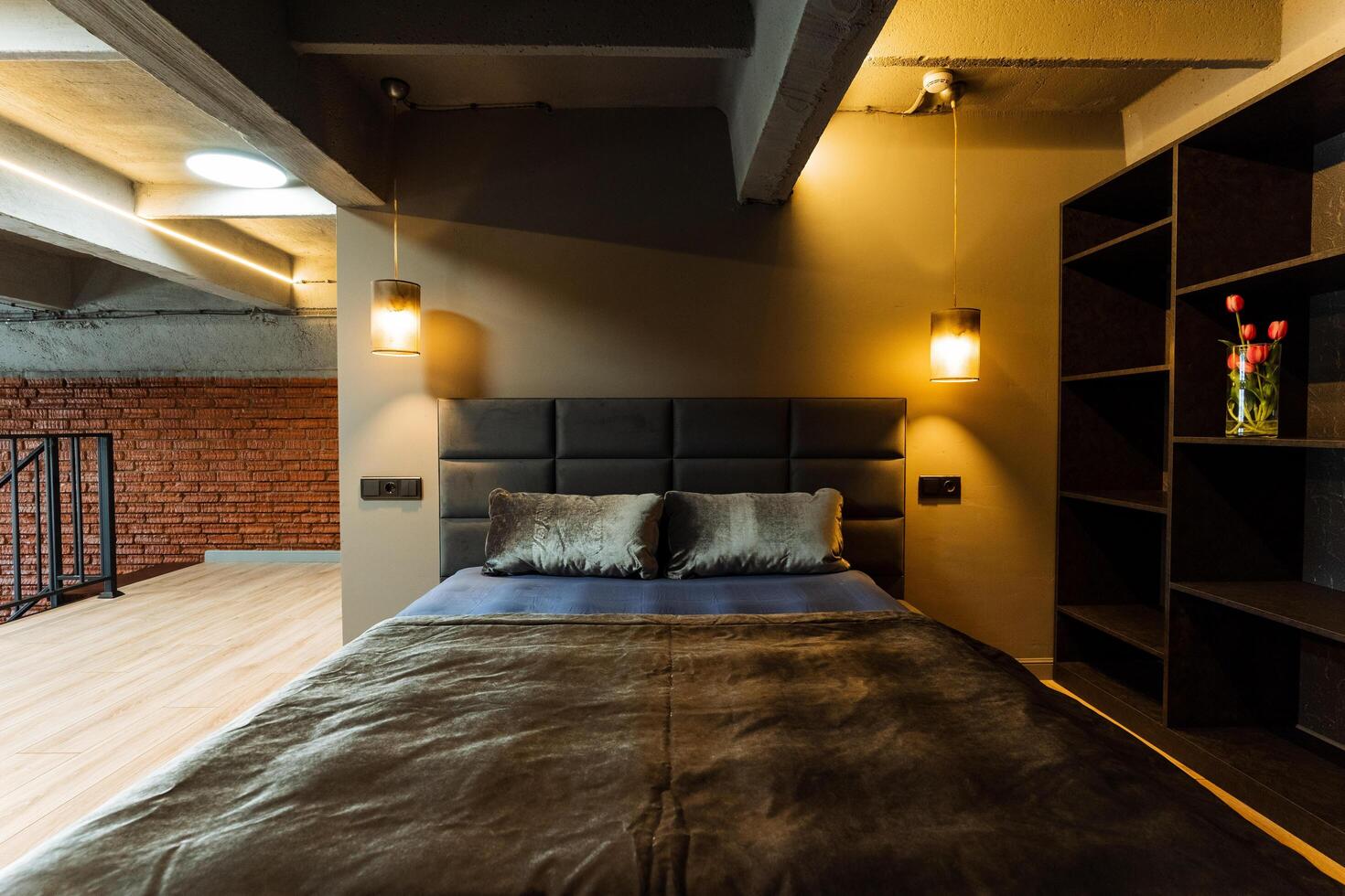 A modern loft bedroom with an industrial aesthetic, sleek design, and cozy ambiance, perfect for relaxation. It showcases stylish furniture for ultimate comfort and luxury living 54865884 Stock Phot