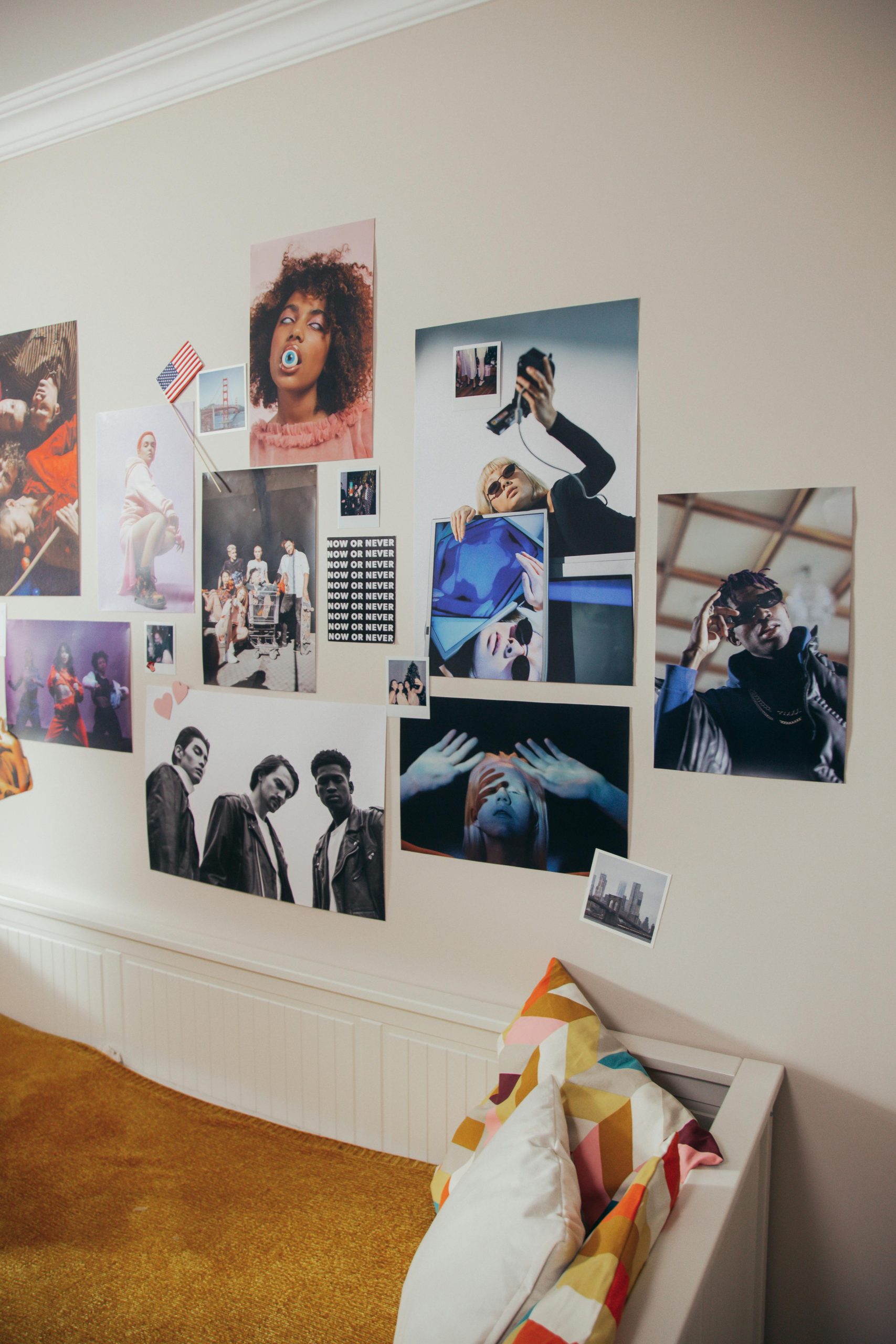 A vibrant teenager's bedroom showcasing modern art posters and creative decoration on the wall.