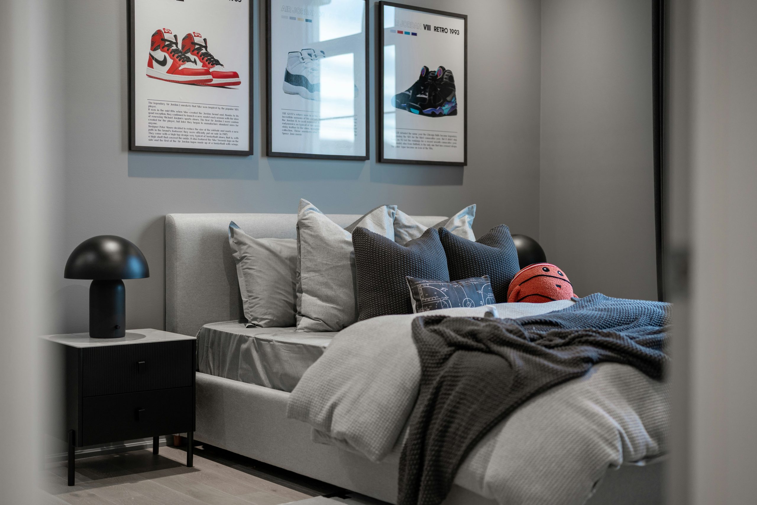 Bedroom with framed sneakers and a basketball.