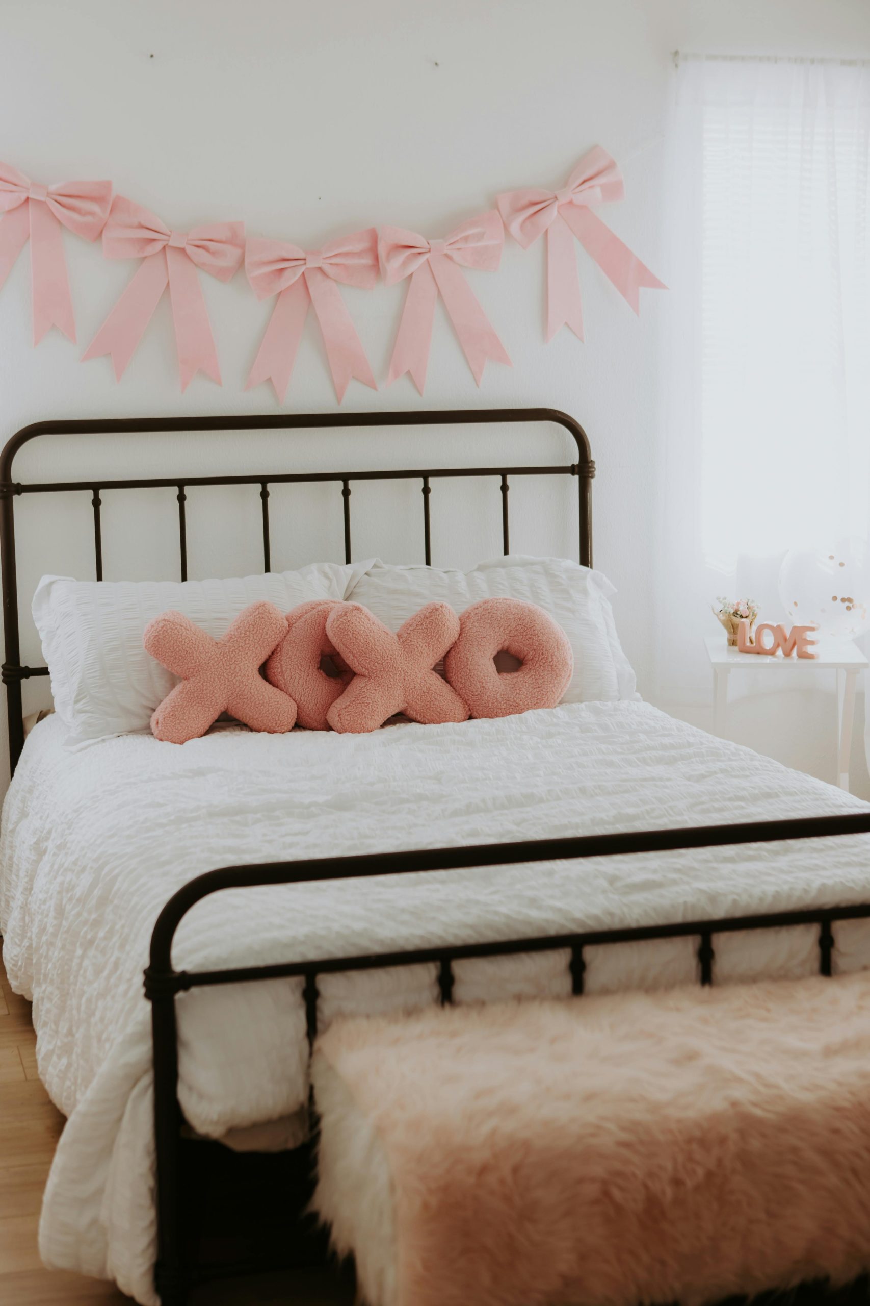 black metal bed with pink bows