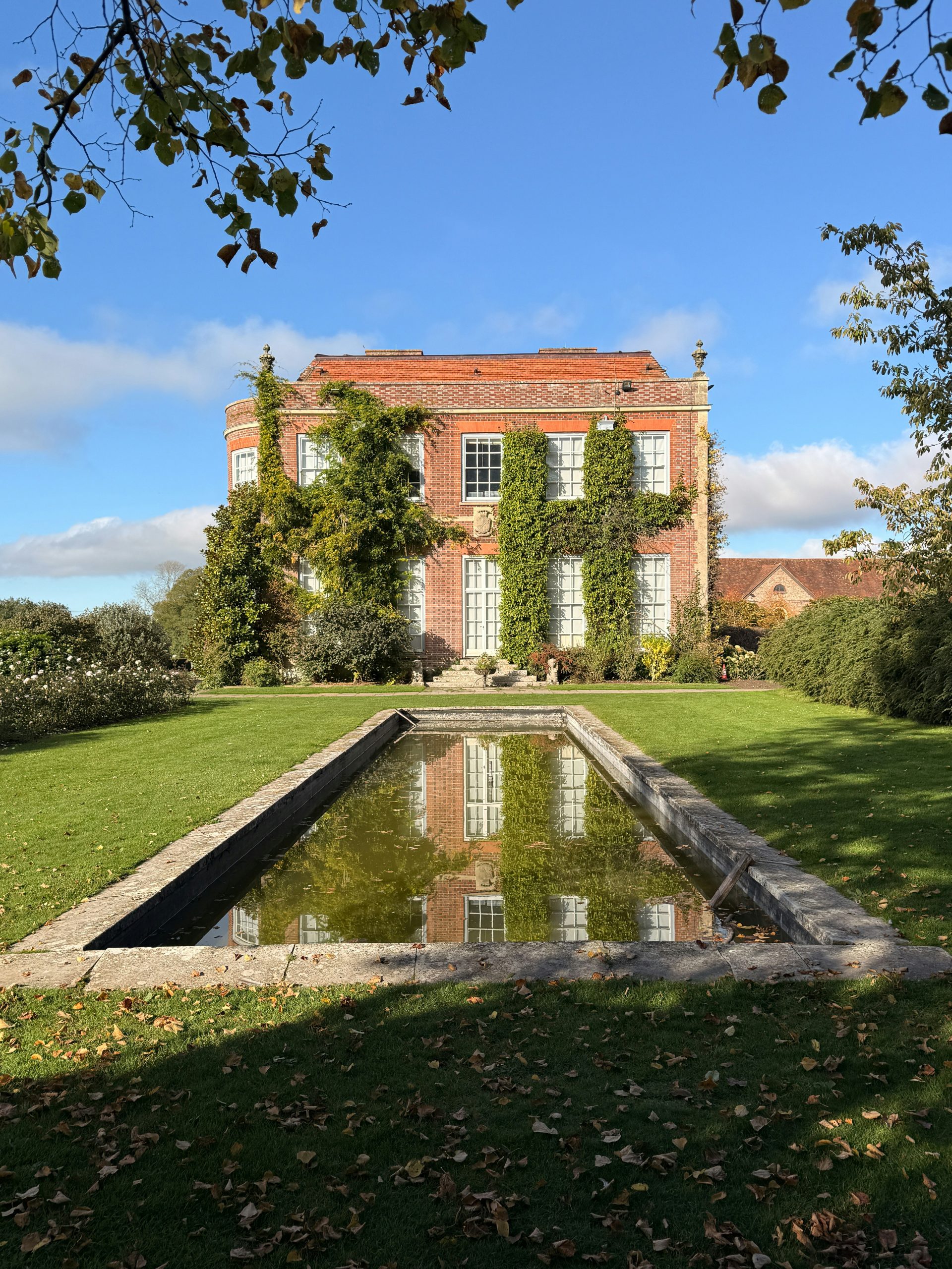 Brick manor house with reflecting pool and garden