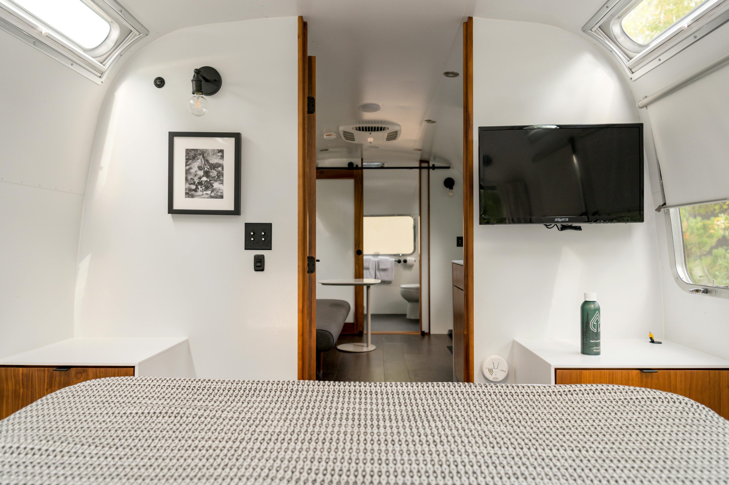 Bright and cozy interior of a modern airstream with stylish design elements, perfect for glamping.