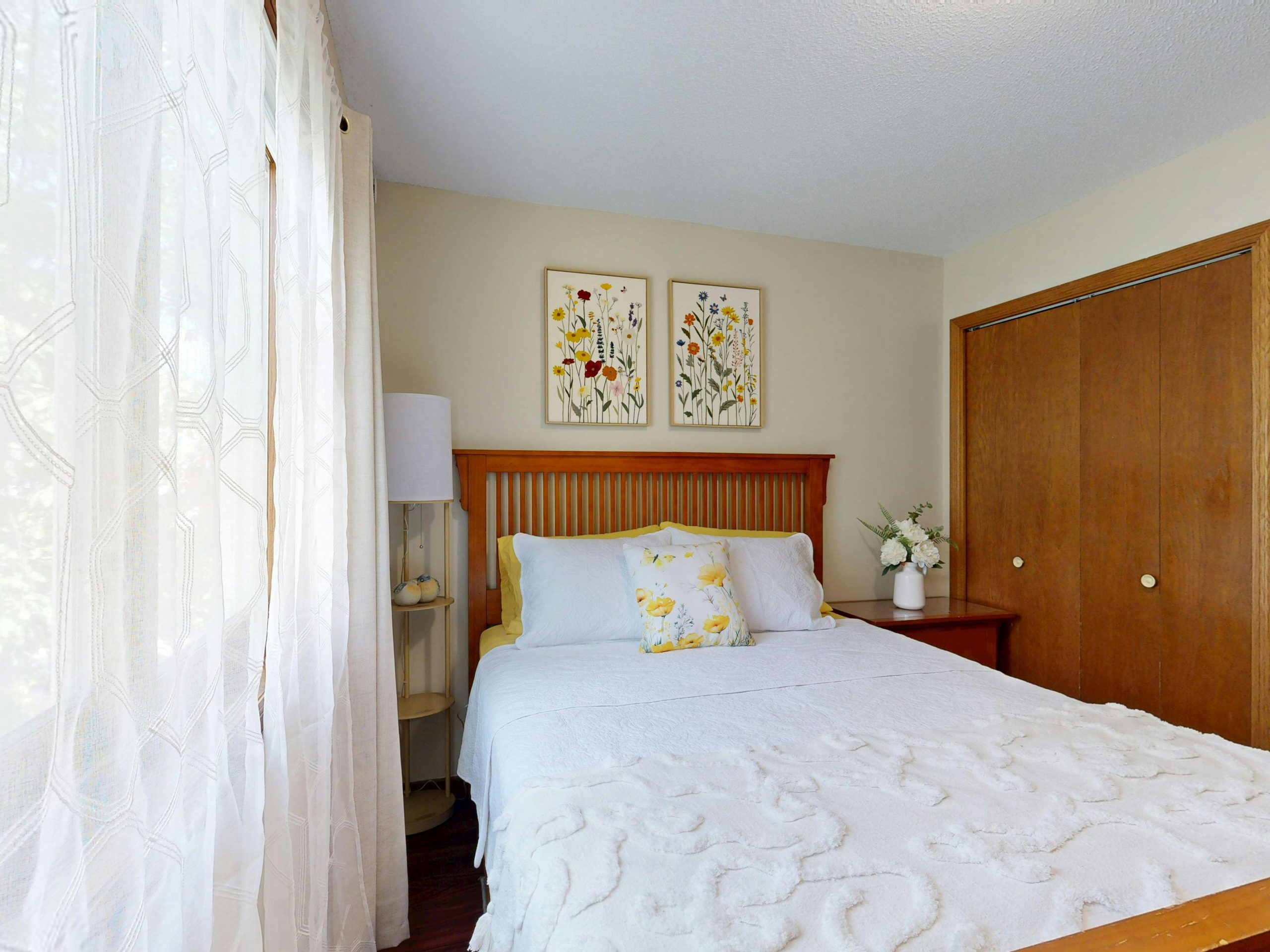Bright bedroom with floral decor and wooden elements. Perfect for home decor inspiration.