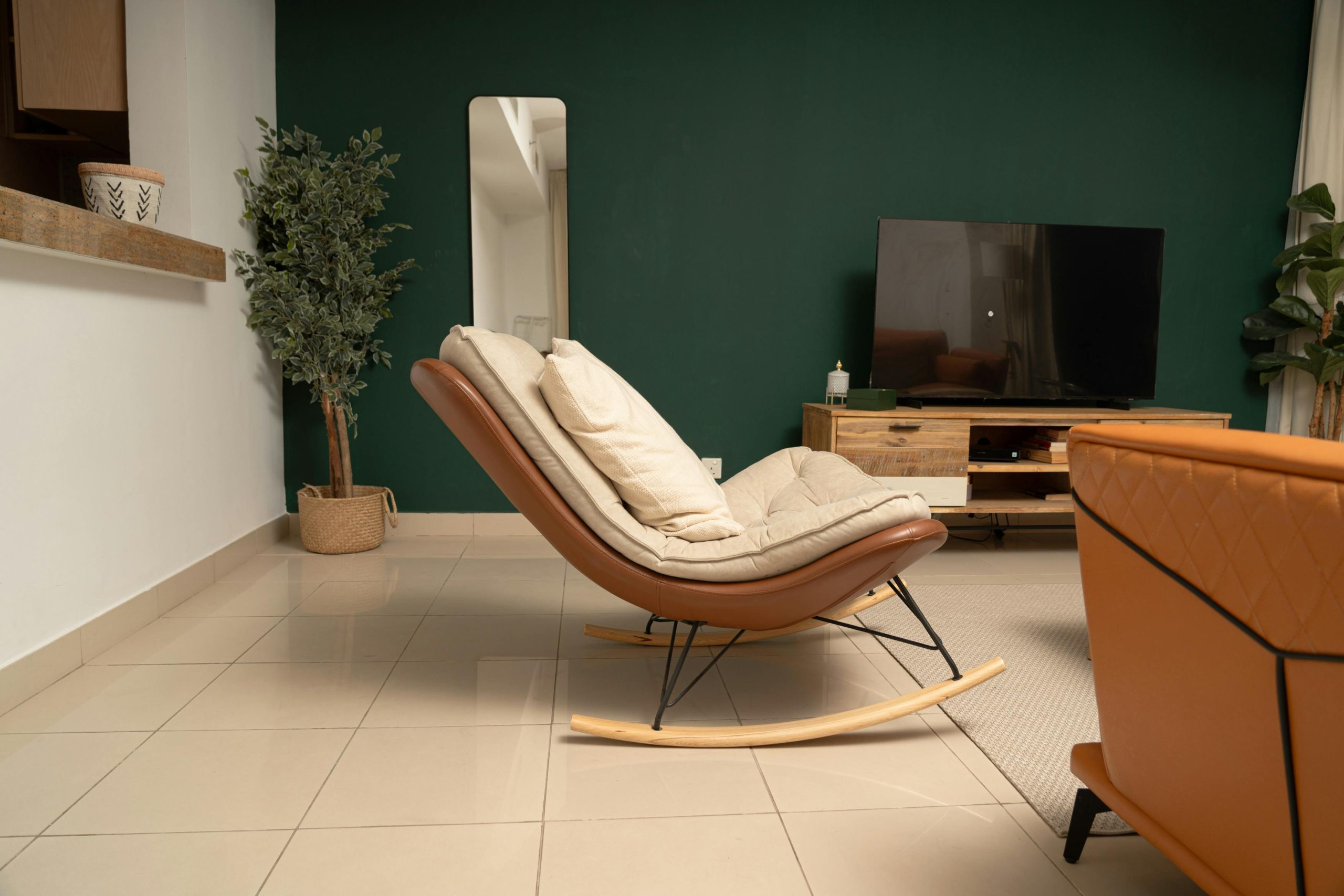 Contemporary living room interior in Dubai with a stylish rocking chair and modern decor.