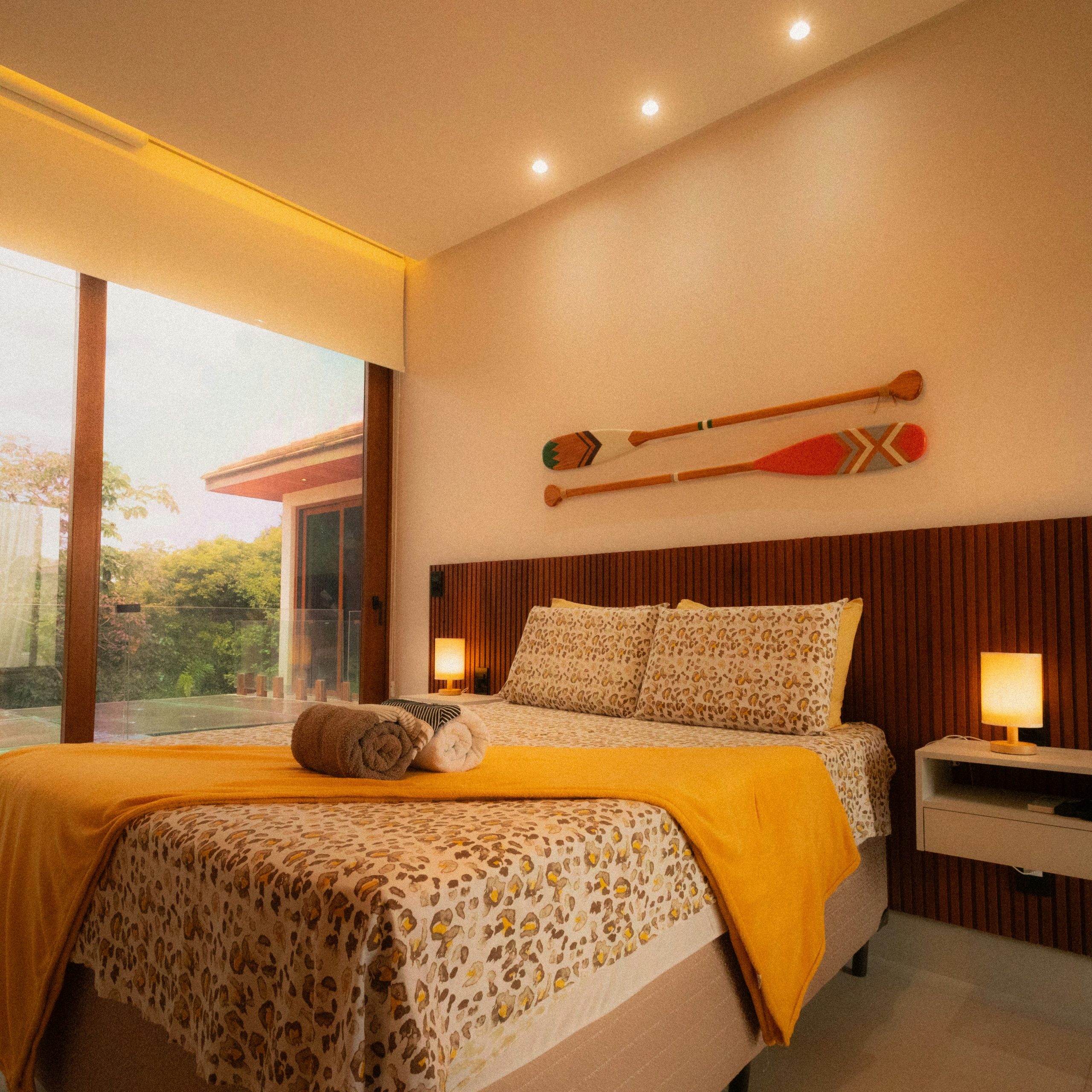 Cozy bedroom with large window and oars on-wall paddles
