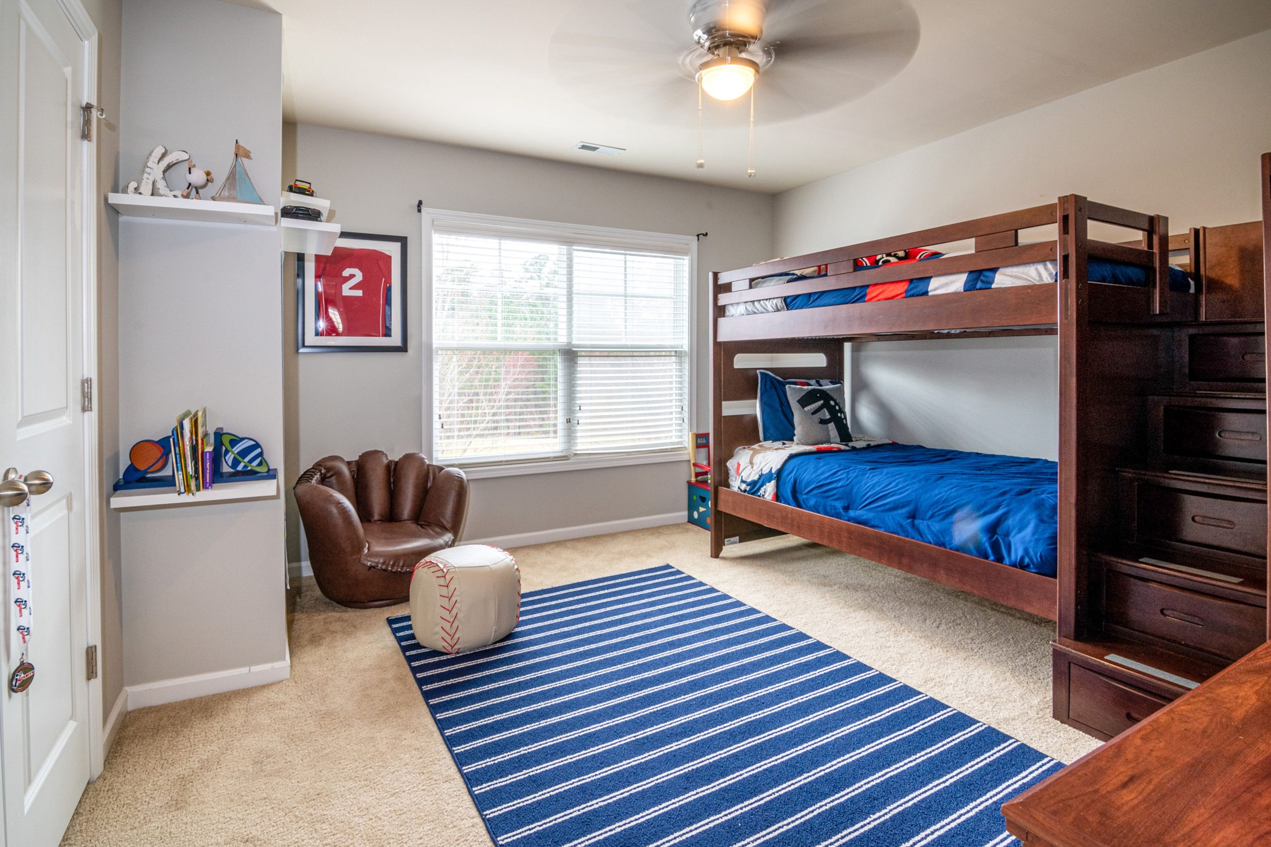 Cozy child's bedroom featuring a bunk bed, baseball theme, and interior design elements.