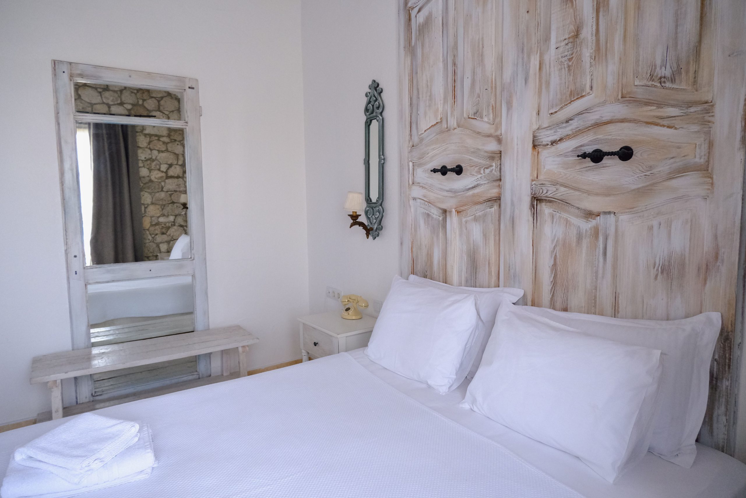 Cozy rustic bedroom featuring vintage decor, soft lighting, and elegant wooden furnishings.