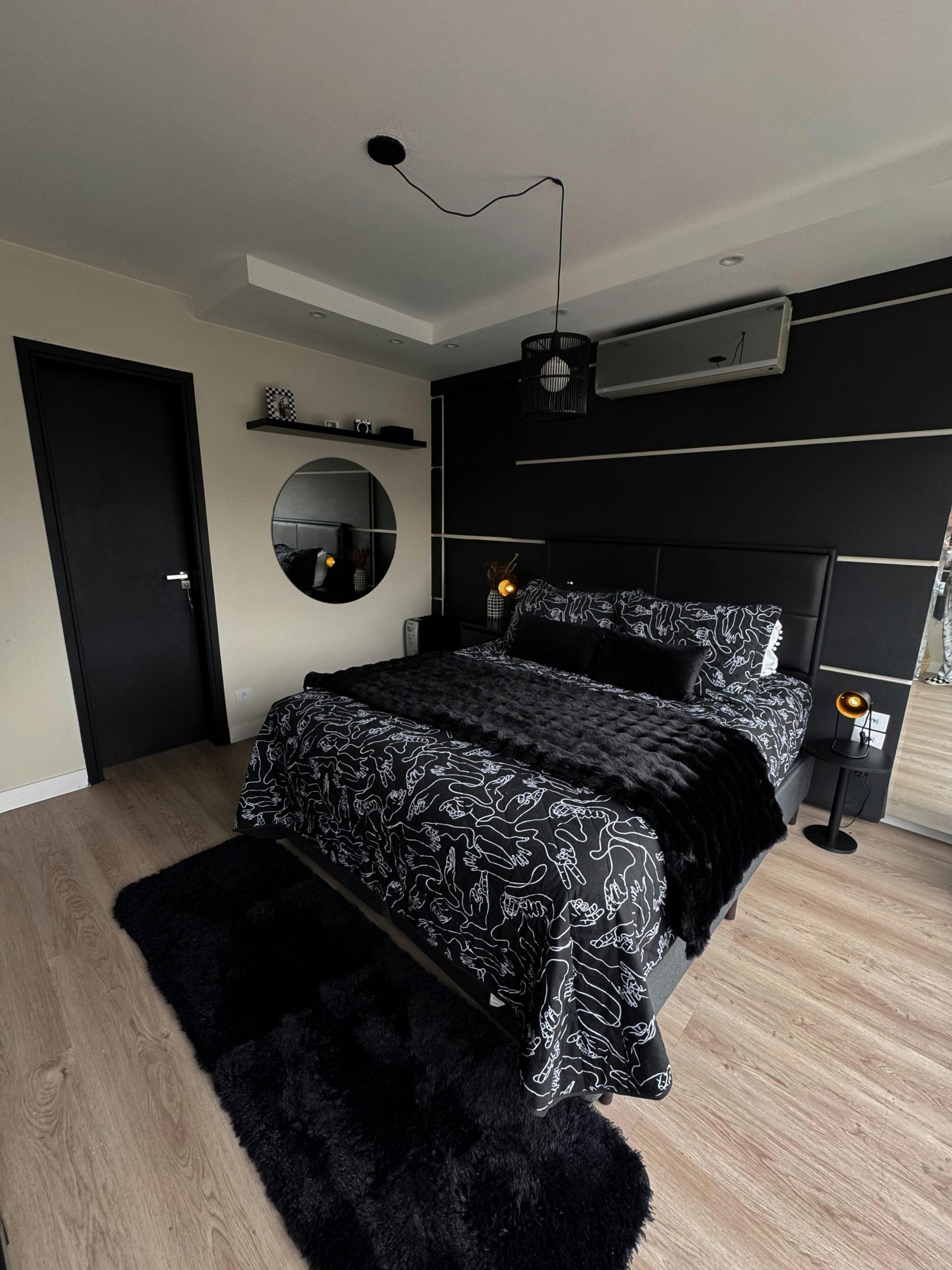 Elegant black-themed bedroom with modern decor and chic design elements.