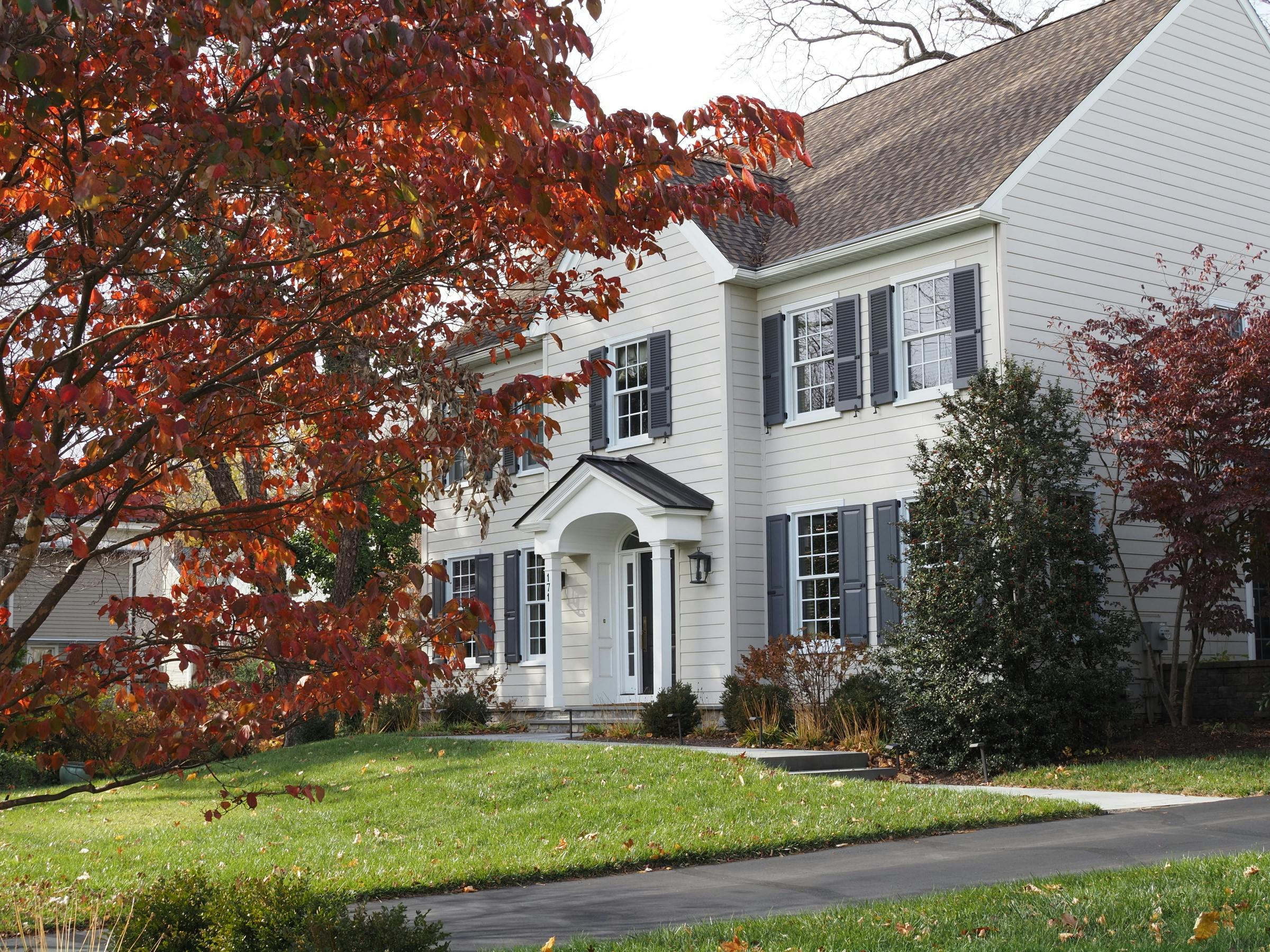 Elegant colonial house surrounded by vibrant fall foliage in Doylestown, PA.