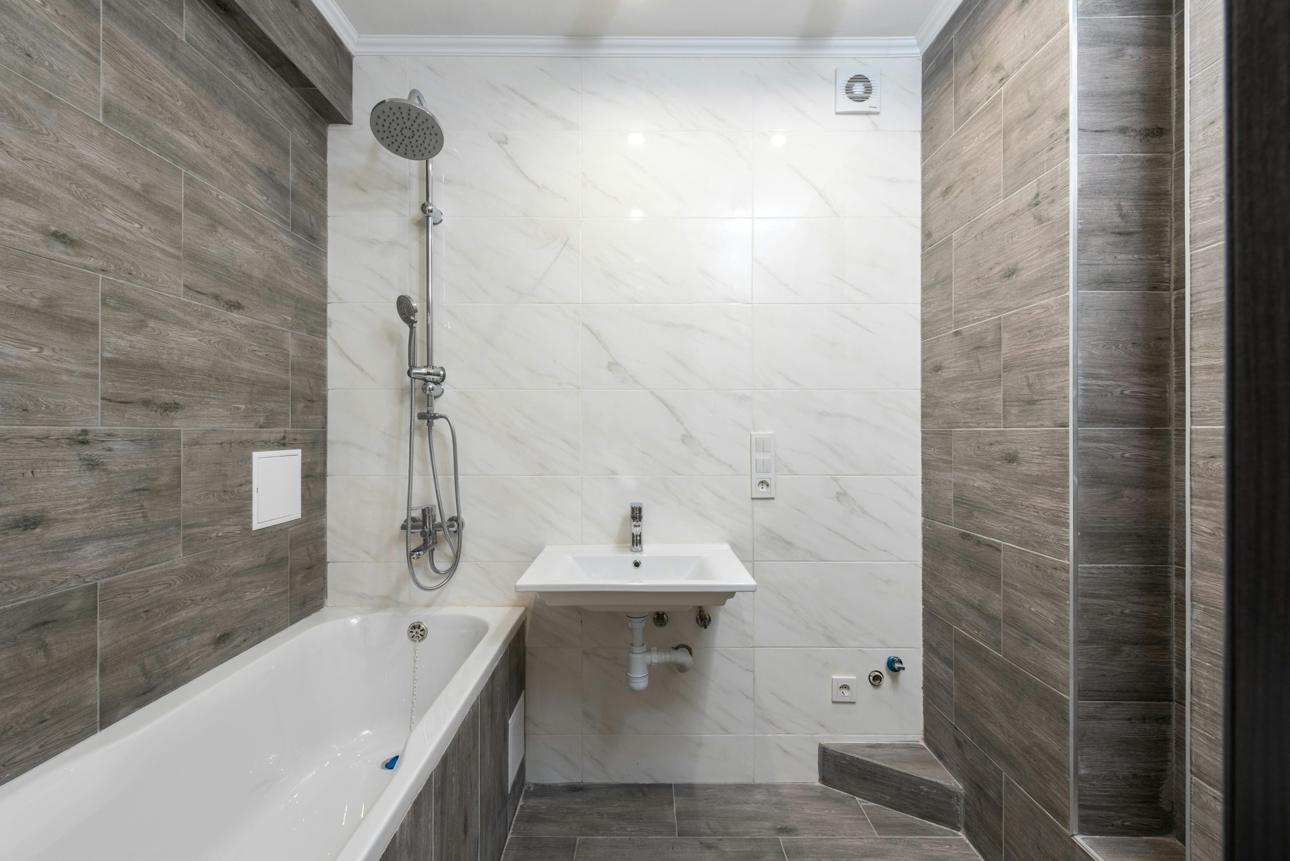 Elegant modern bathroom interior with wooden details and sleek design.