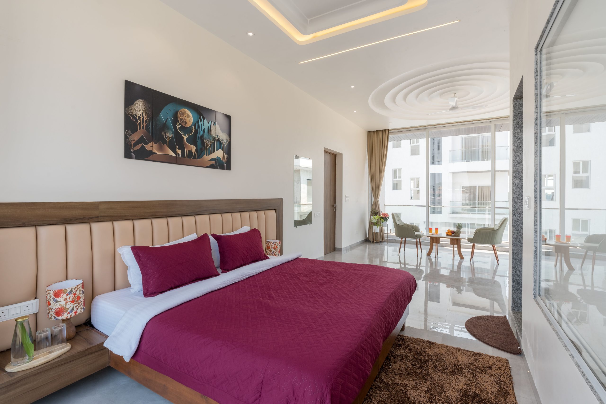 Elegant modern bedroom featuring vibrant decor, unique artwork, and stylish furnishings.