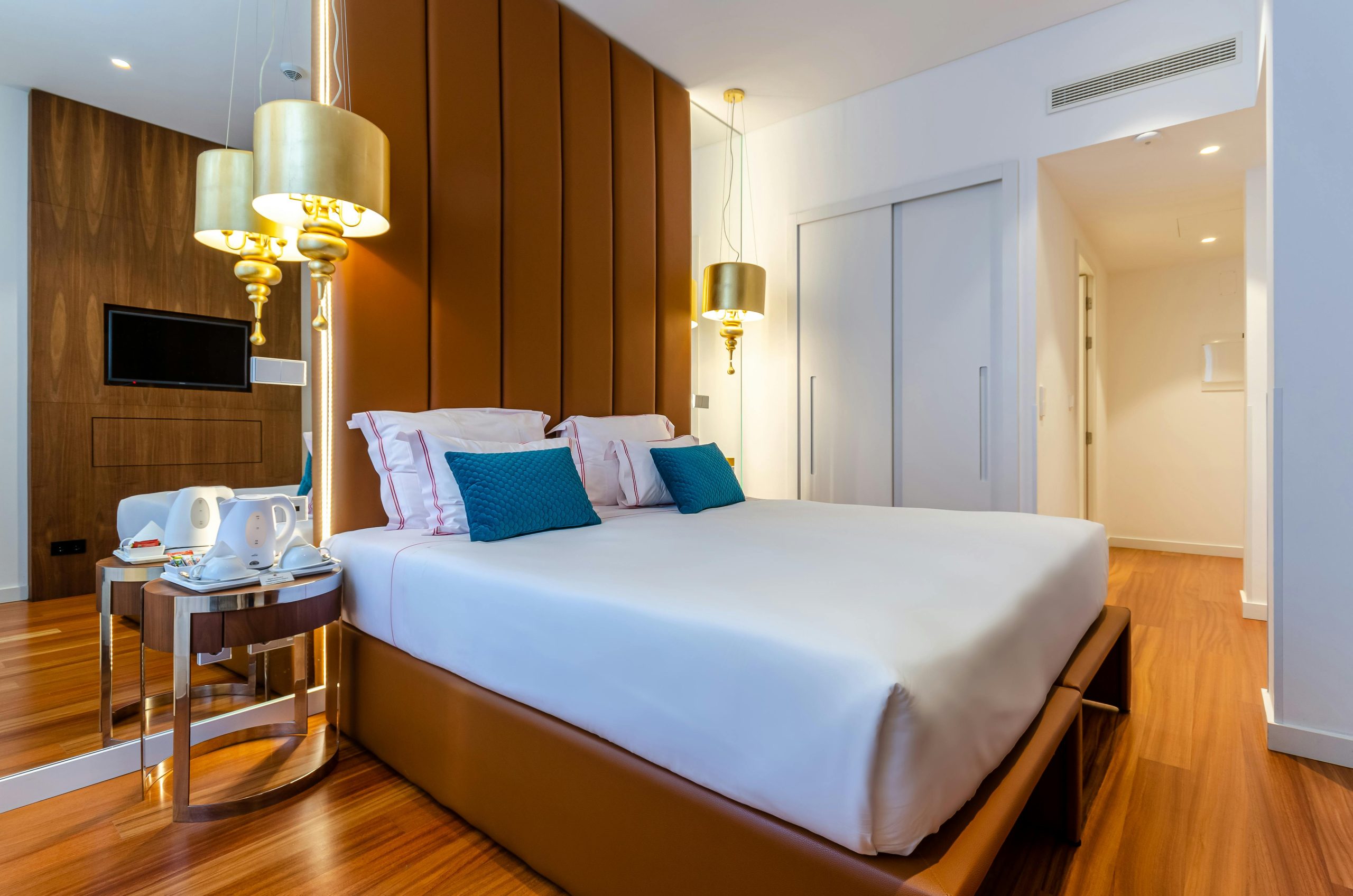 Elegant modern hotel room with plush bedding and warm lighting in Lisbon, Portugal.