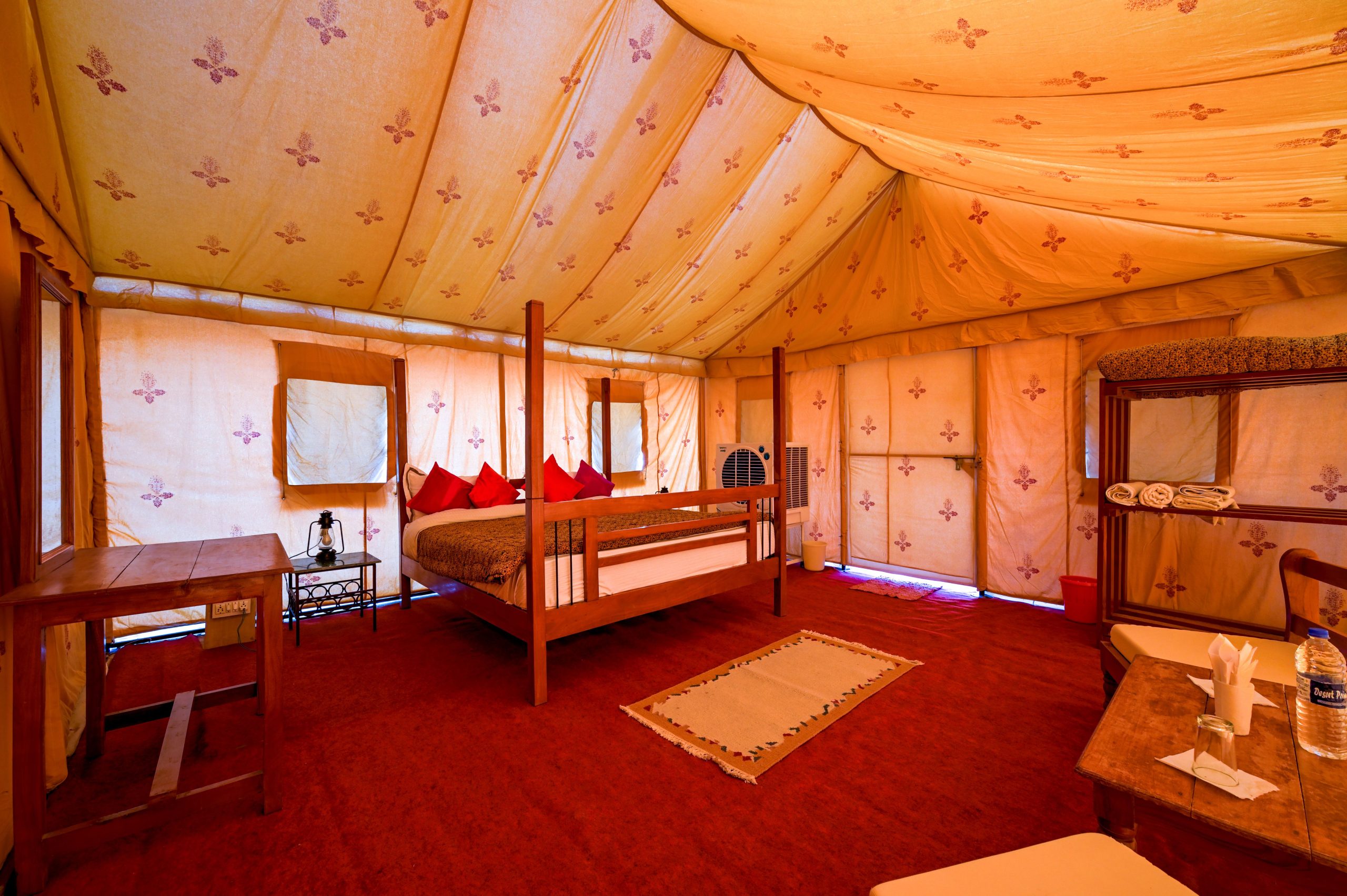 Explore the cozy interior of a desert camp tent in Jaisalmer, India, featuring elegant decor and comfort.